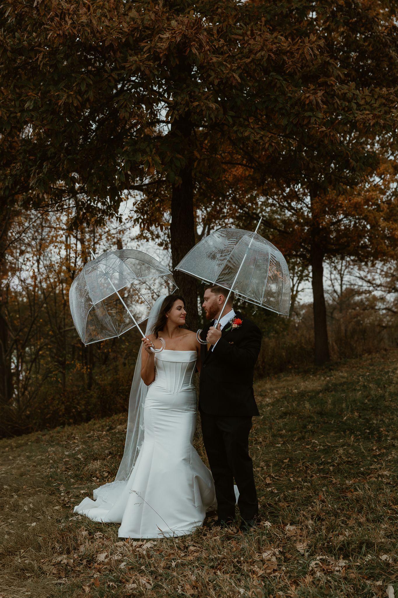 Bride and Groom share an intimate stare during rainy wedding portraits captured by central illinois wedding photographer