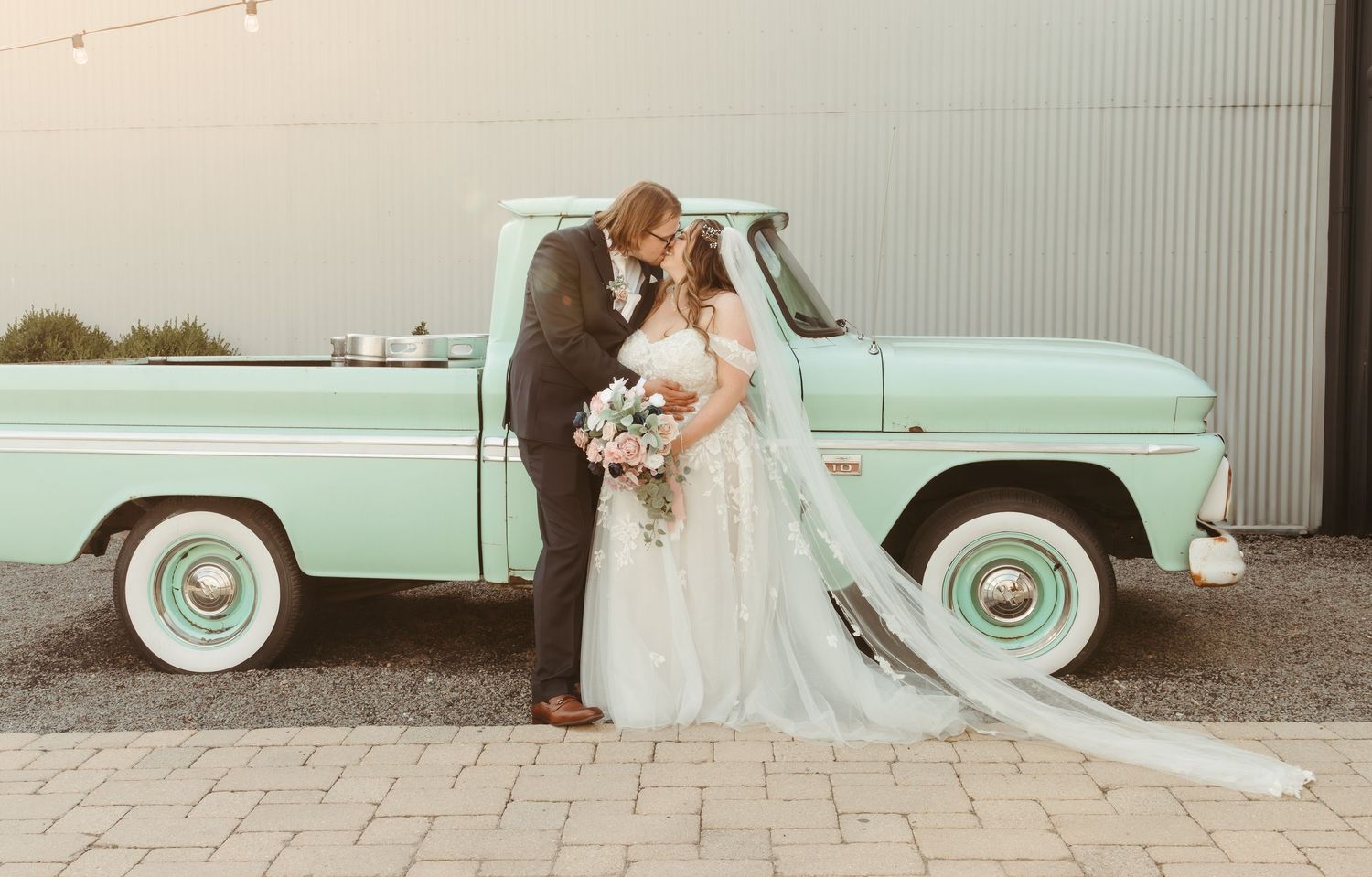 Bride and groom kissing in front of a vintage truck on their wedding day ; Washington Elopement Photographer