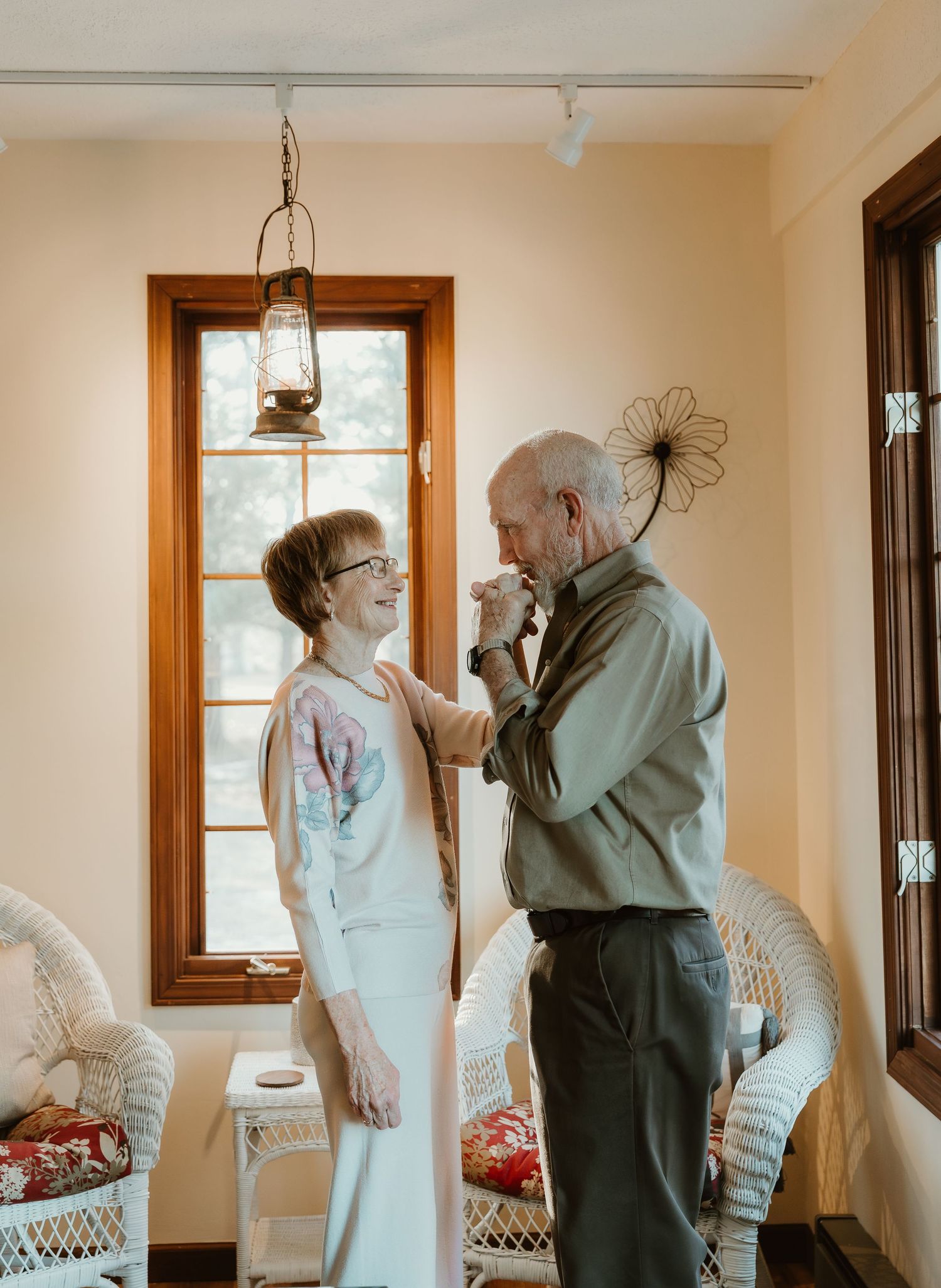 Husband kisses wifes hand during their anniversary photo session with central il photographer