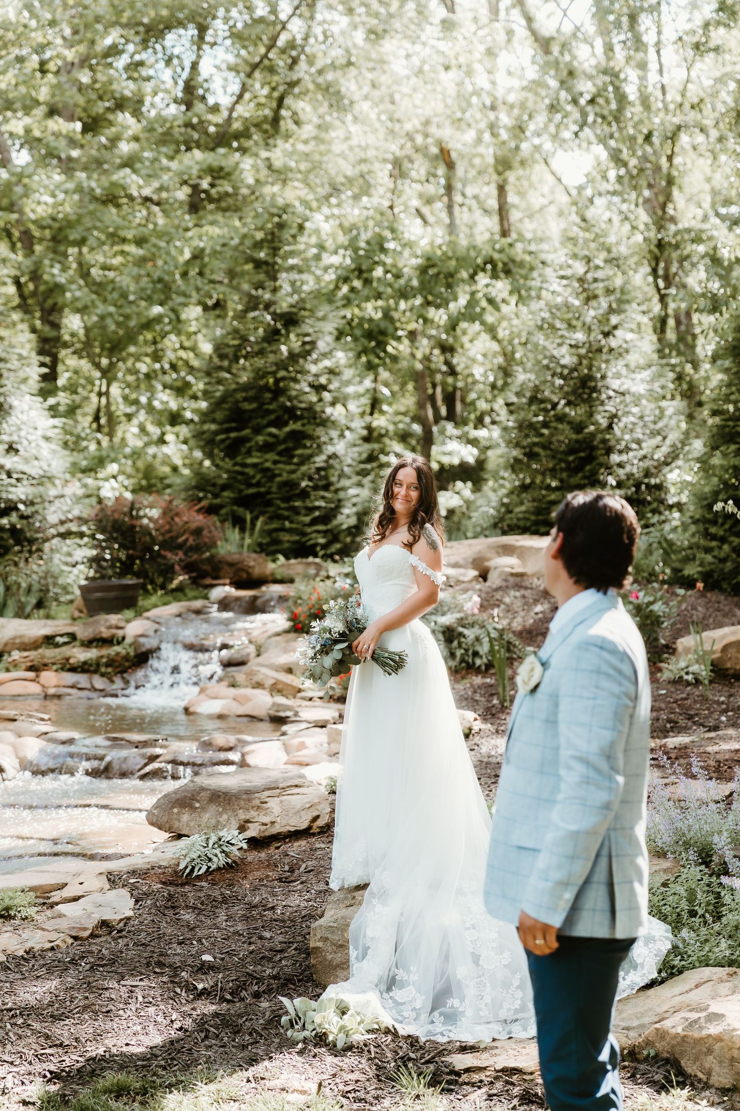 Groom intimately stares at his bride during wedding portraits at dragonfly wedding venue captured by central il wedding photographer