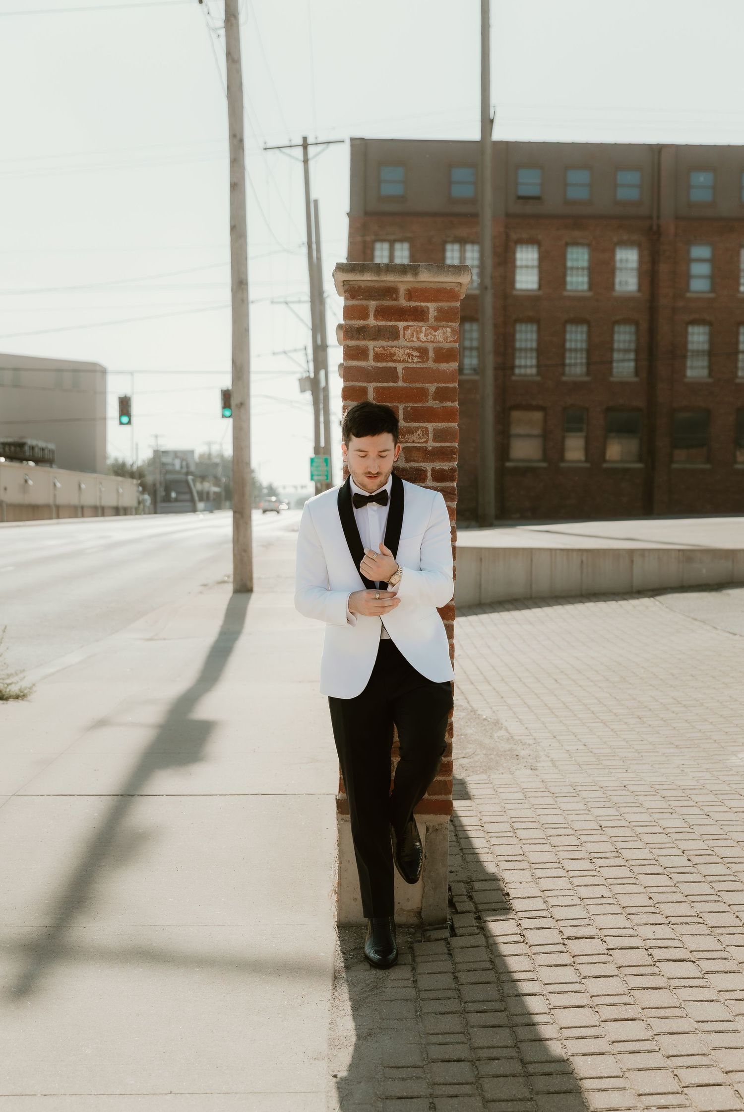 Groom portraits outside of Venue Chisca in Peoria, IL captured by central illinois wedding photographer