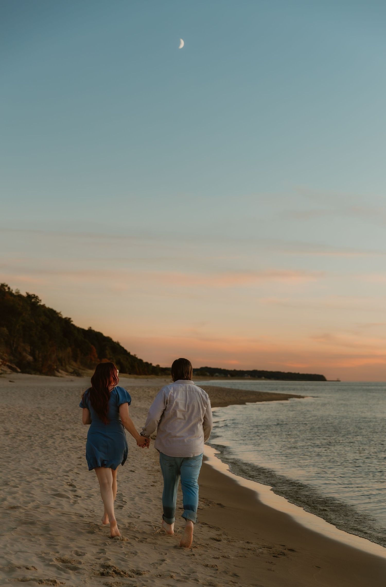 Couple strides along lake michigan during golden hour with illinois wedding photographer for their engagement photos