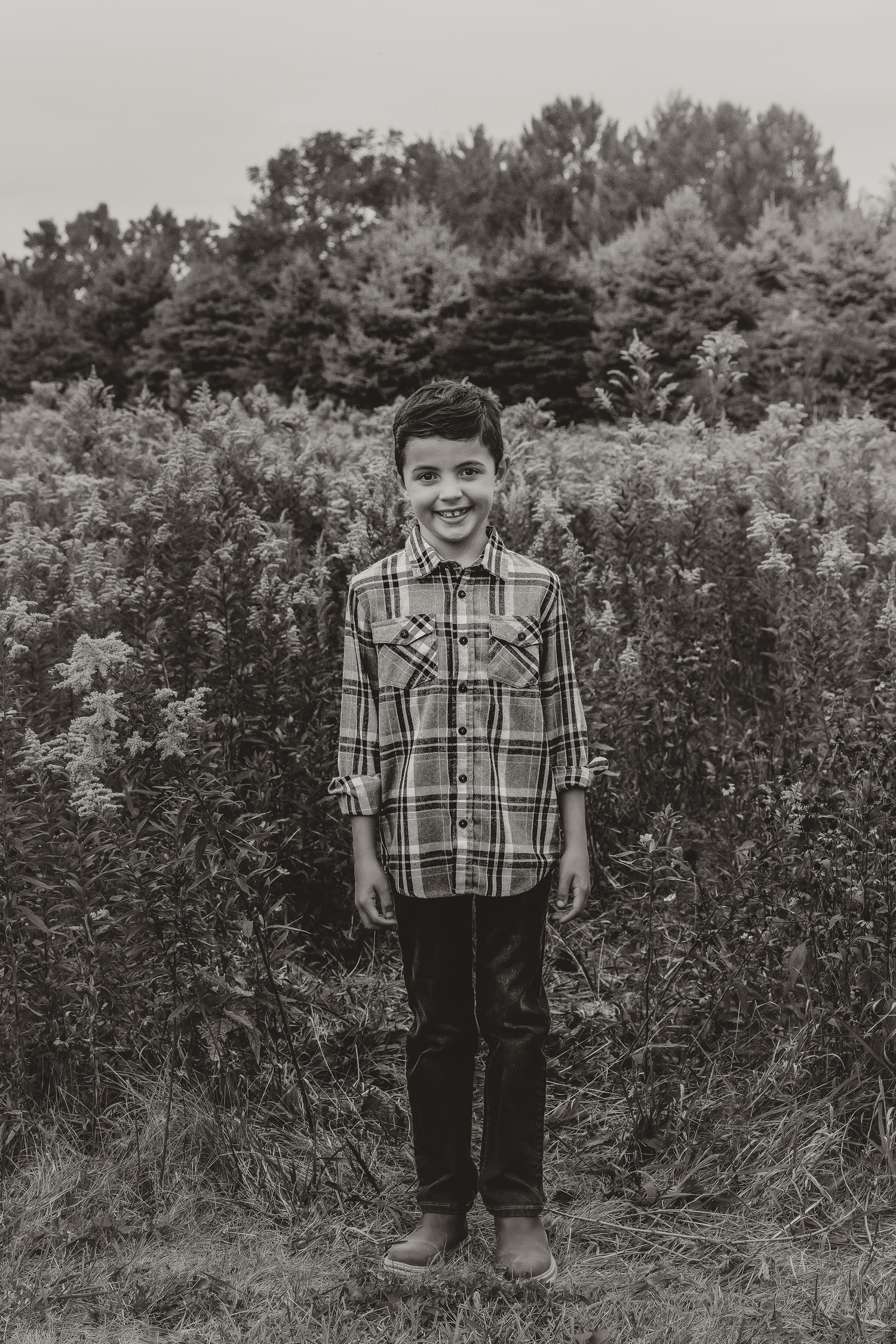 Son poses for a self portrait during a family photo session documented by bloomington il family photographer