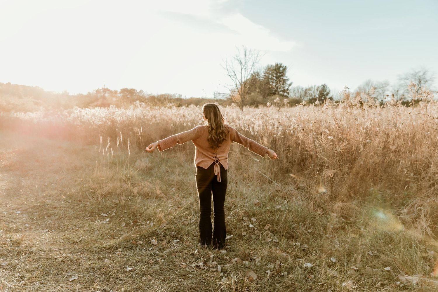 High school senior standing in an embrace stance taking in anything the future has in store for her