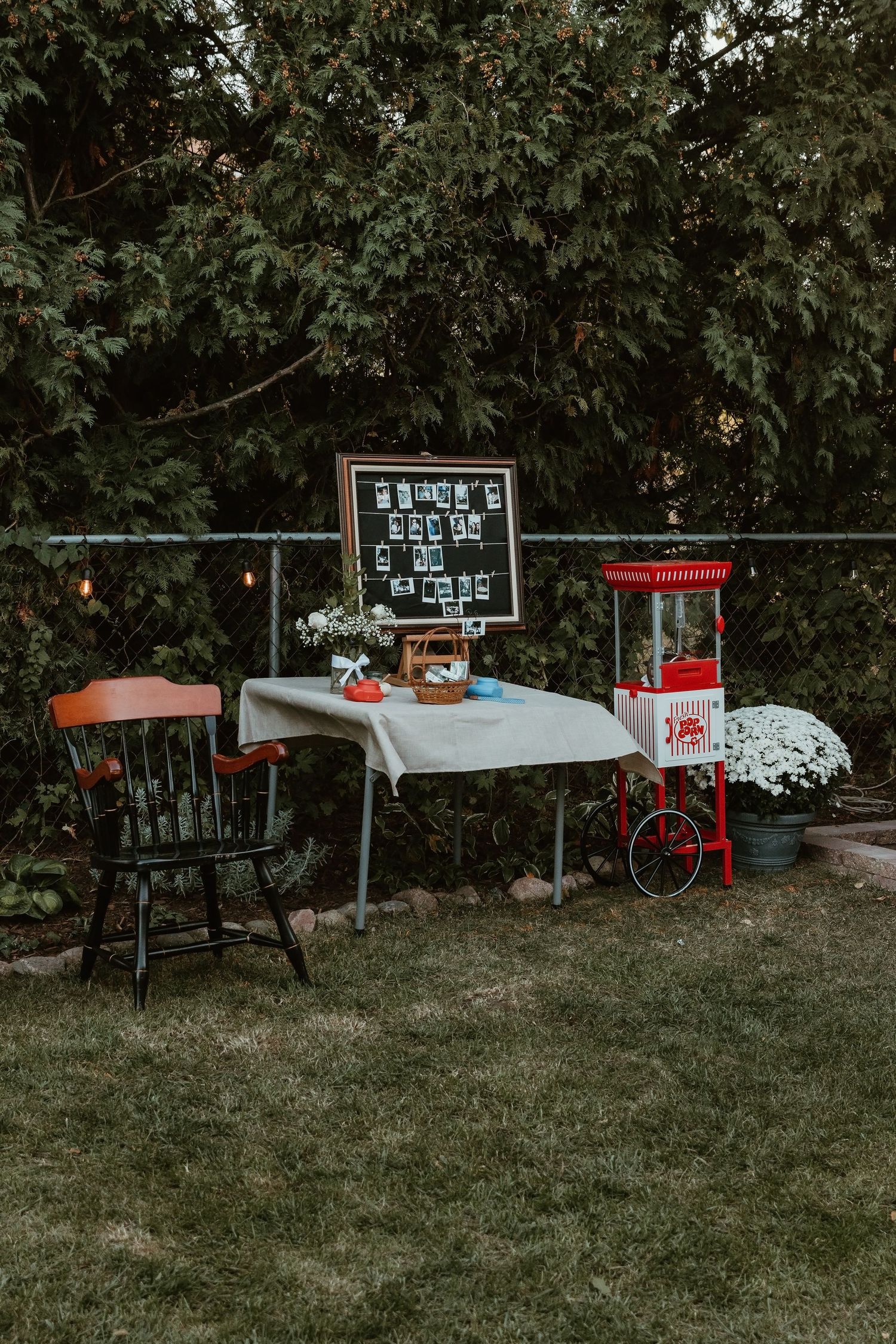 Wedding reception decorations featuring a vintage popcorn machine and a Polaroid camera station, adding a fun and nostalgic touch