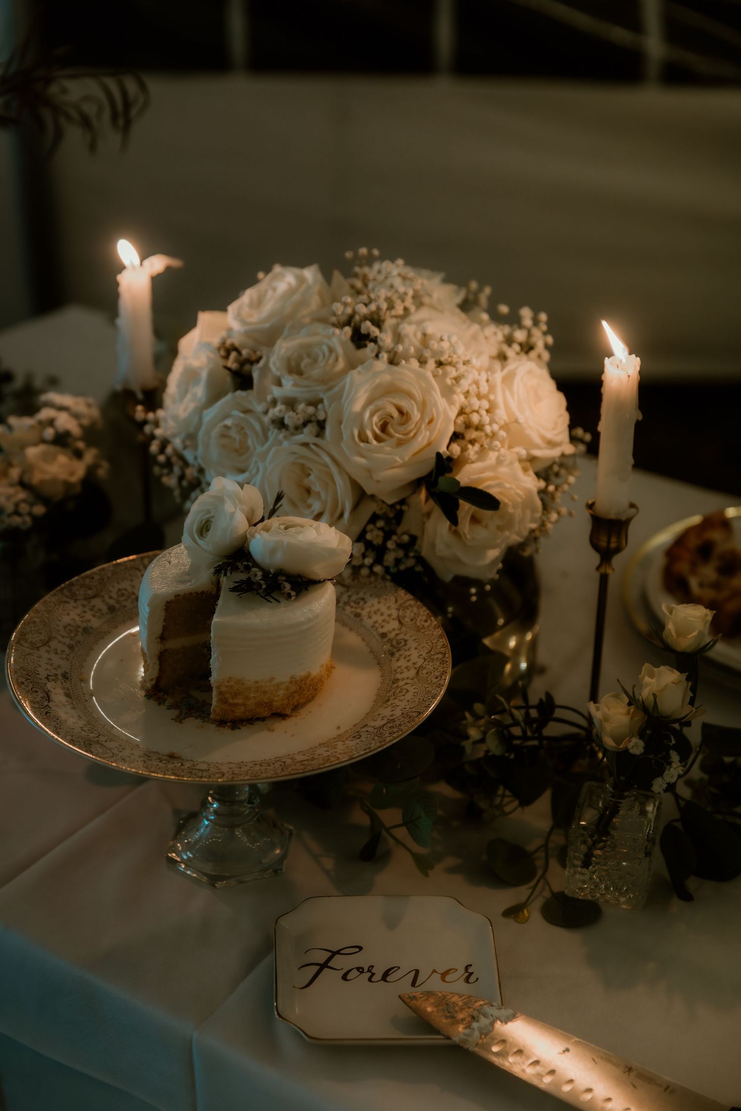 Bride and Groom candlelit table with their cake captured during wedding reception with illinois wedding photographer