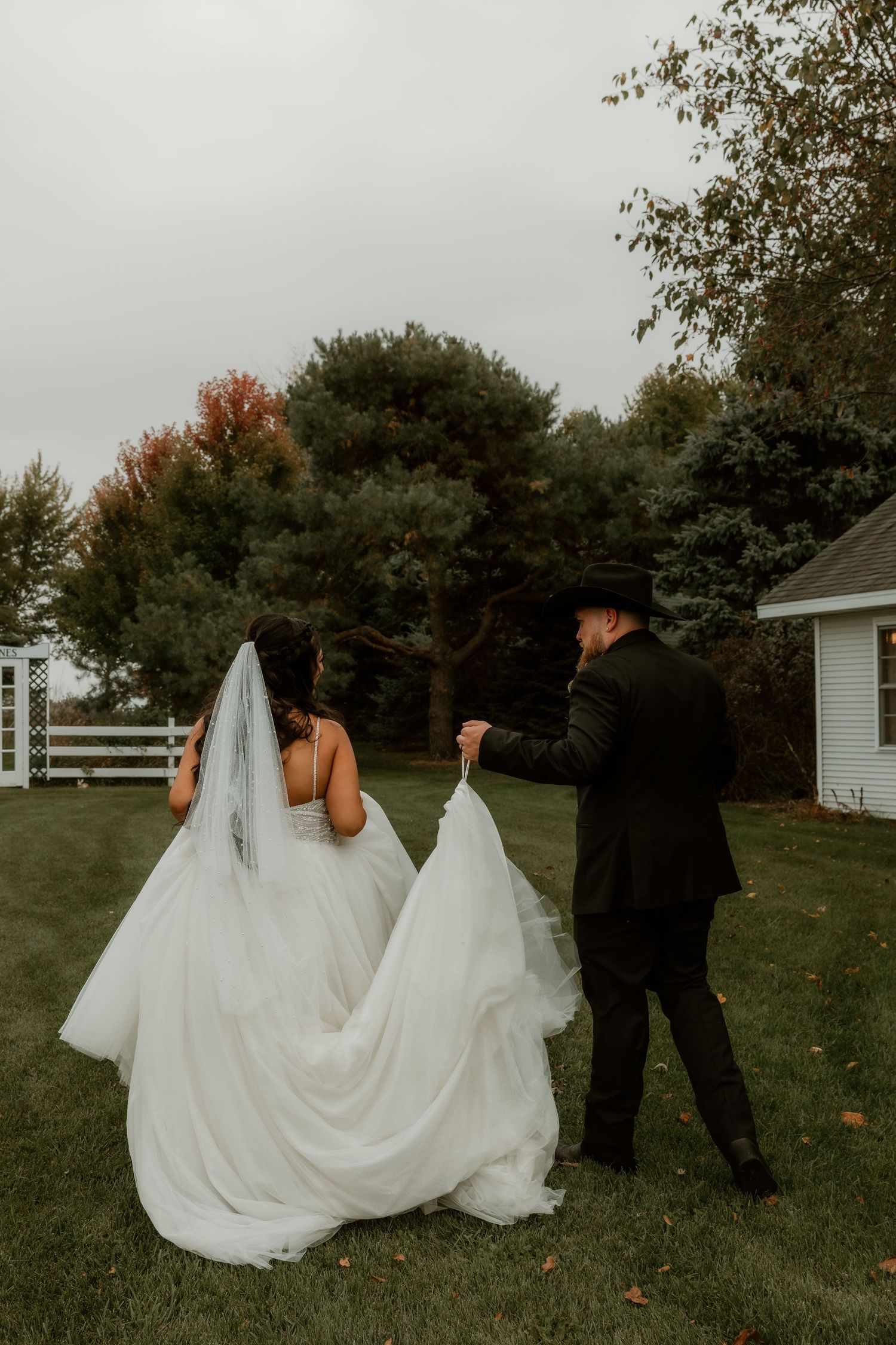 Bride and Groom walking to the next photo spot during wedding party portraits captured by central illinois elopement photographer