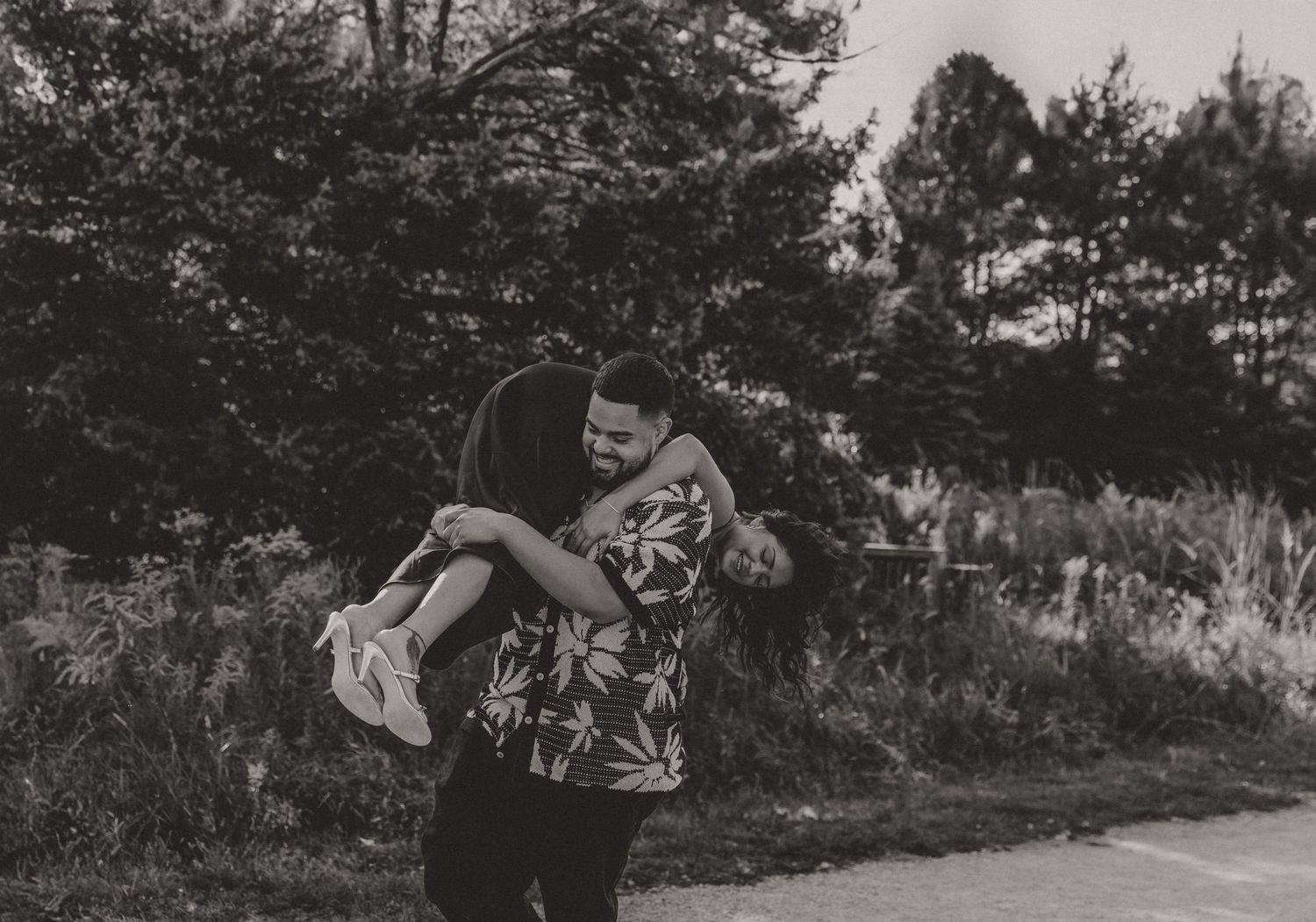 Playful photo of a couple, the guy gently picking up and swaying his lady during their couple photoshoot with central il couple photographer