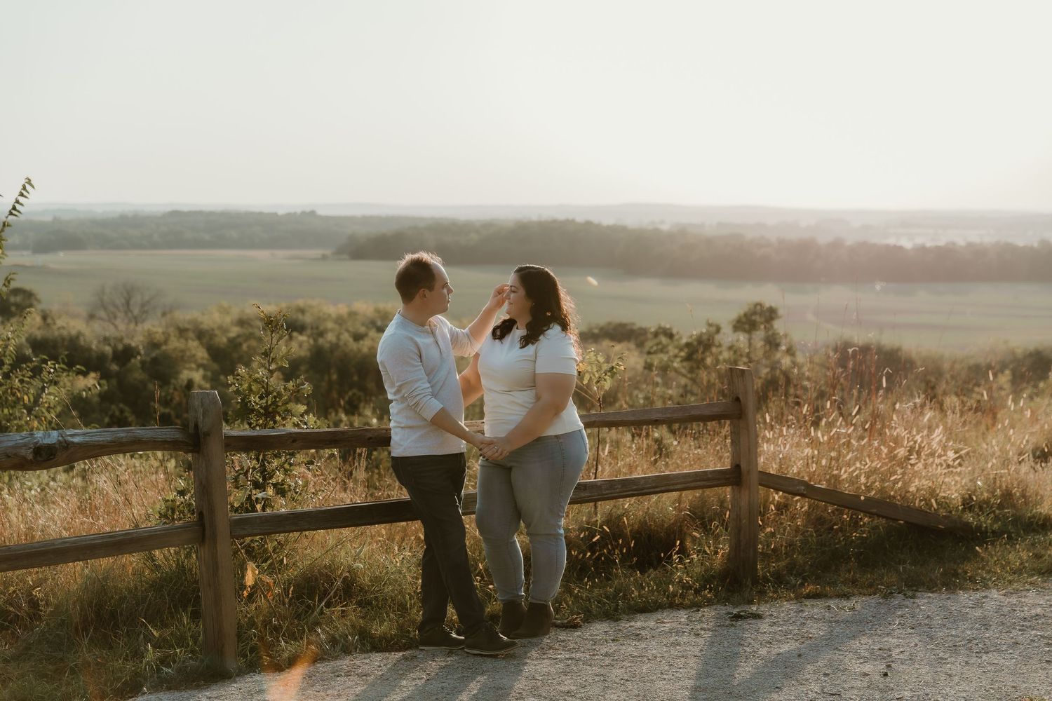 Intimate moment between a couple where the groom is stroking the brides face capturing their connection and love