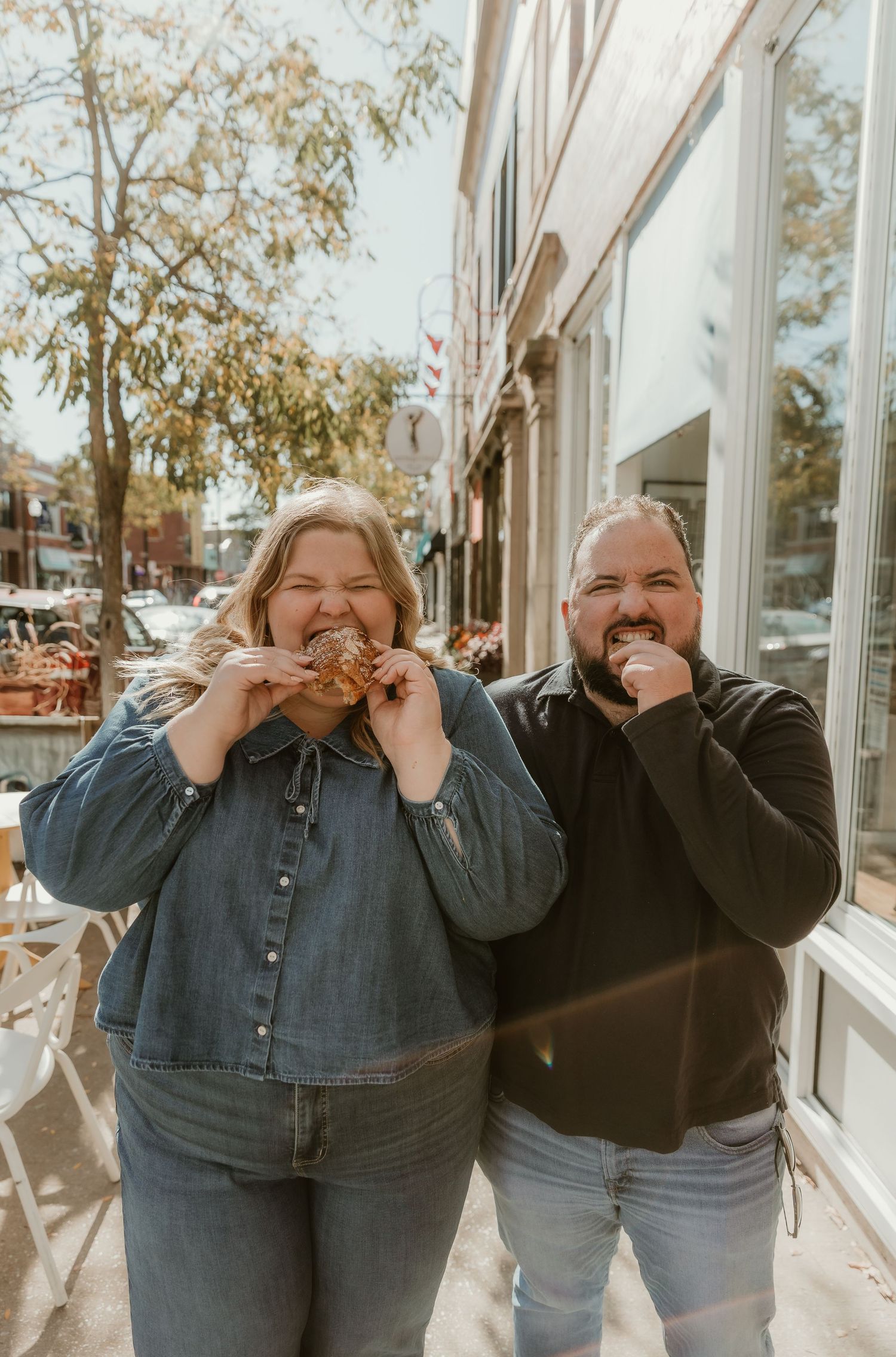 Couple shares a pastry during their engagement session with central illinois wedding photographer