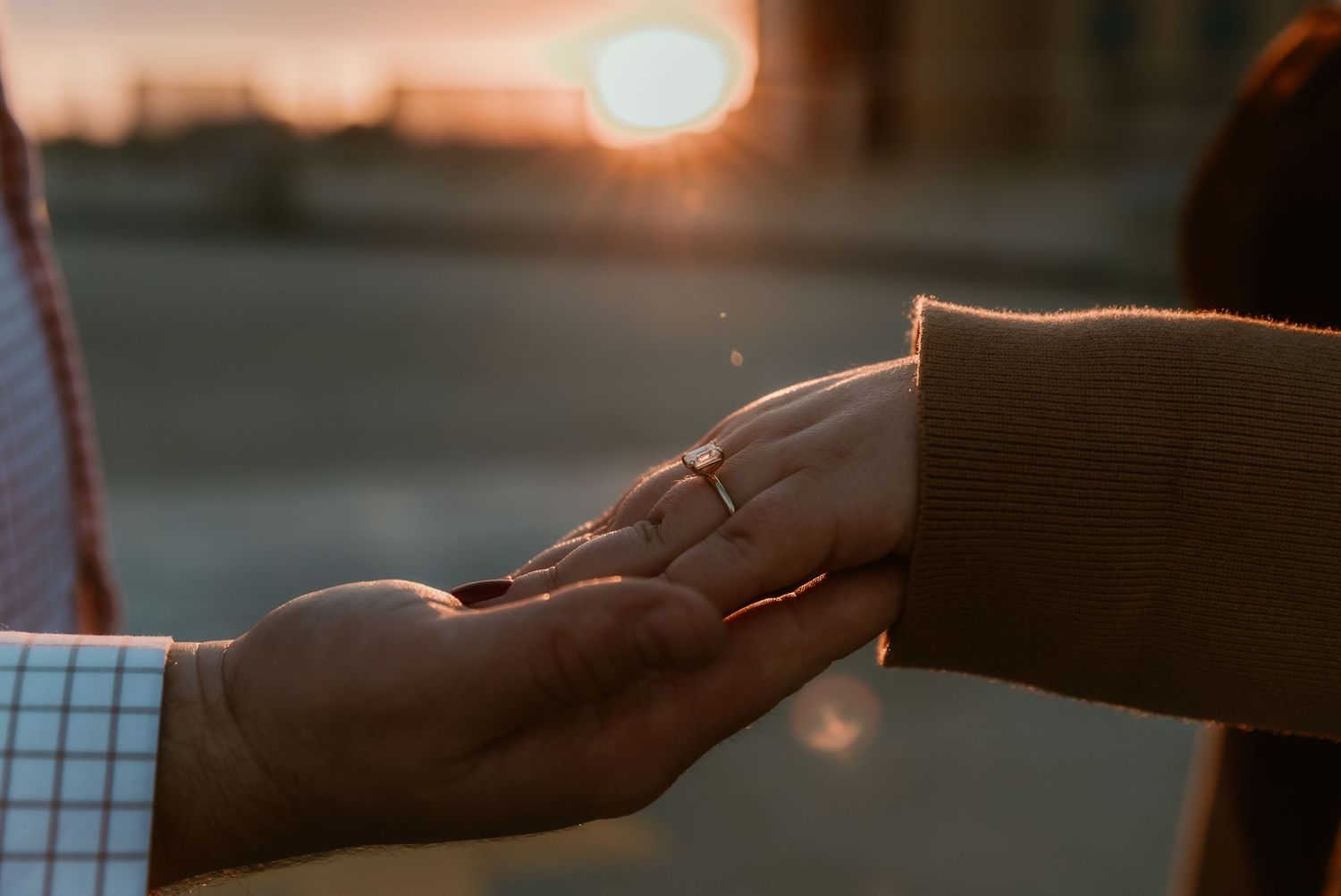 Bride shares her ring while the golden hour sun hugs the diamond with the golden hour light on a rooftop with central illinois photographer