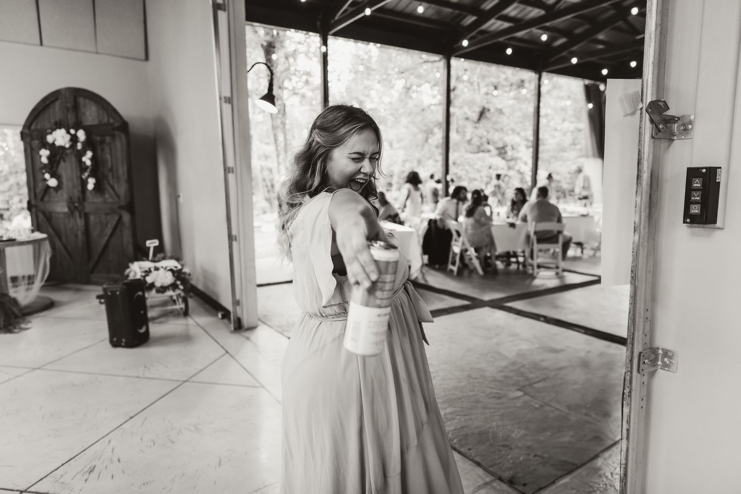Bridesmaid poses for playful photo during wedding reception at dragonfly wedding venue