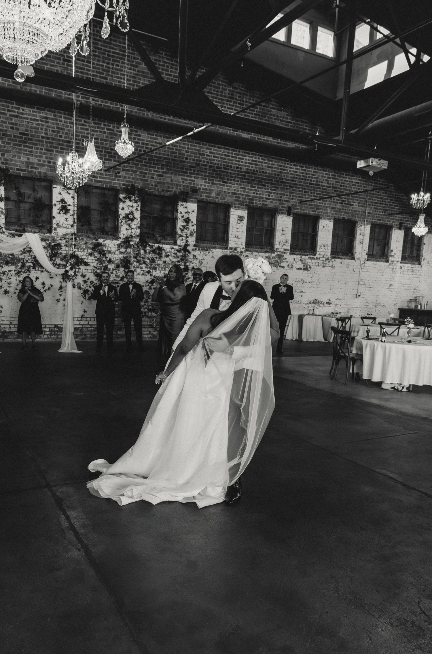 Groom dips bride for a kiss after their wedding ceremony at Venue Chisca in Peoria, IL