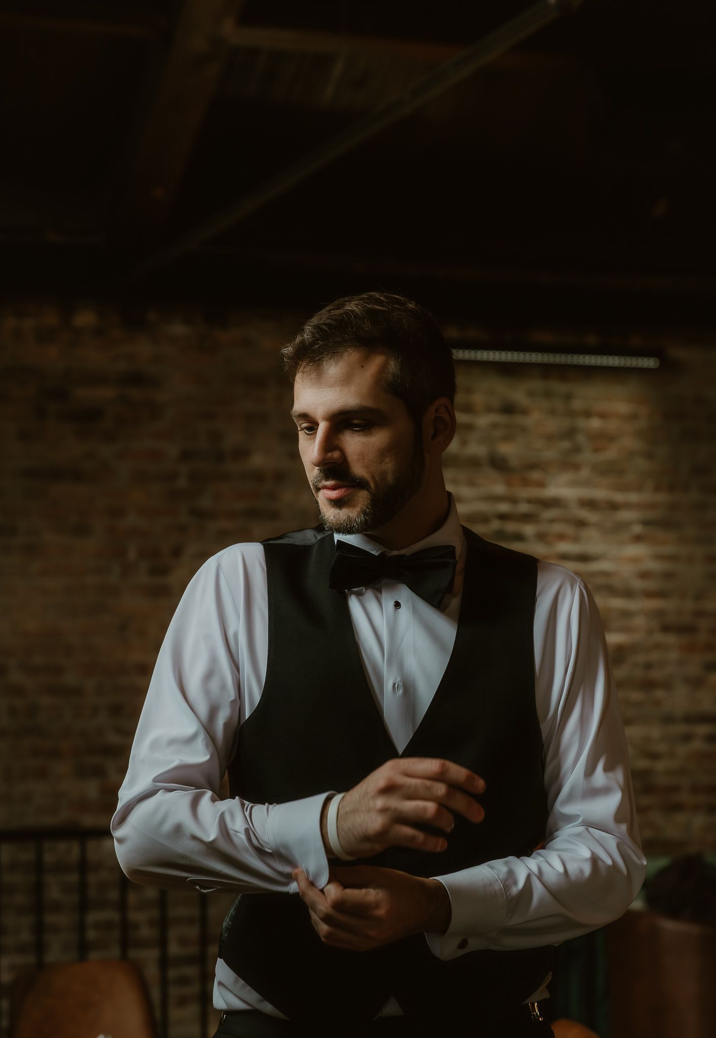 Groom during the final touches of getting ready on his wedding day documented by illinois wedding photographer