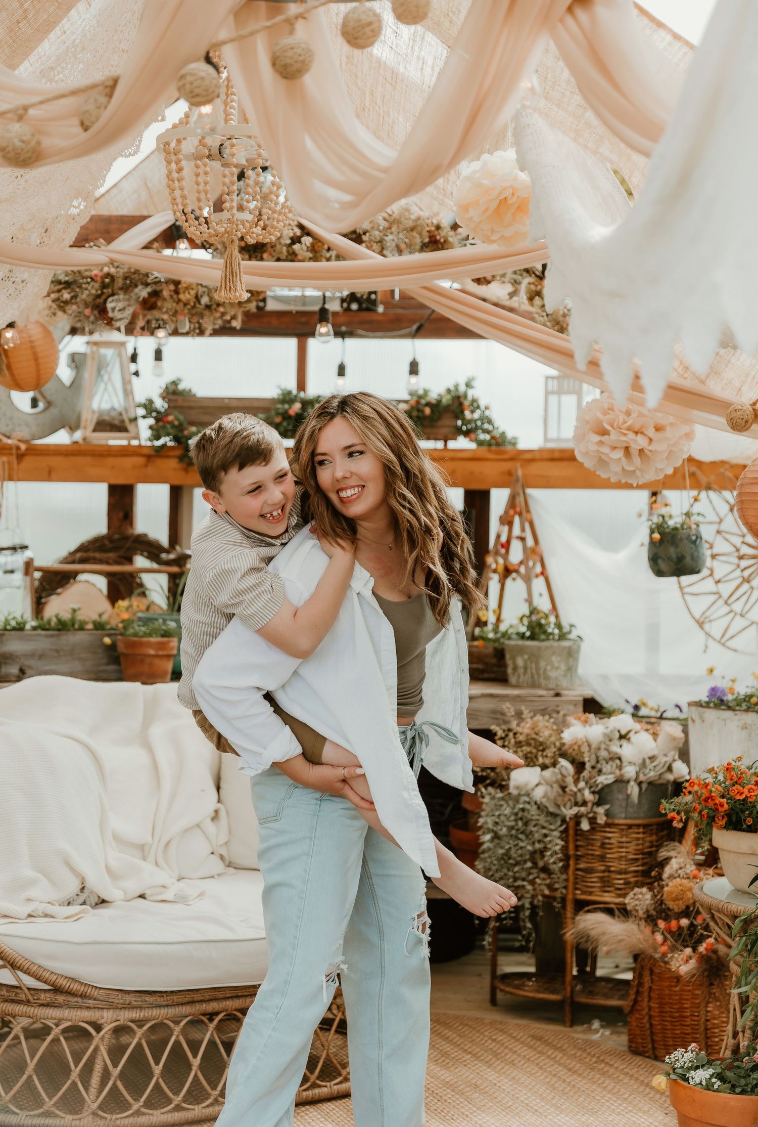 Mother and son pose for a playful piggy back ride during mothers day session with bloomington il photographer