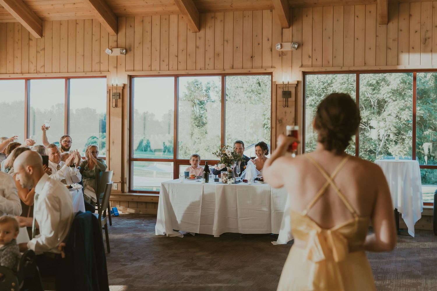 Sister of the bride making a speech to the newly married couple during wedding reception at Tabor Hill Winery in Buchanan, MI