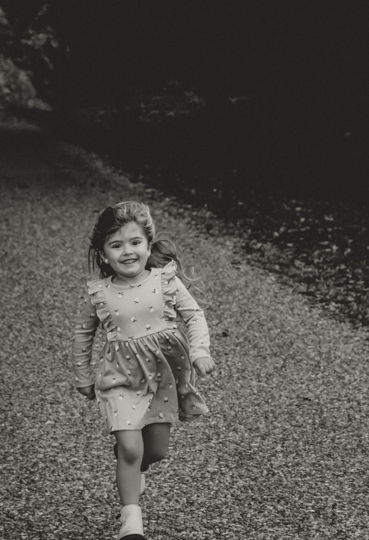 Girl running toward the camera during a lively family photo session with central illinois family photographer