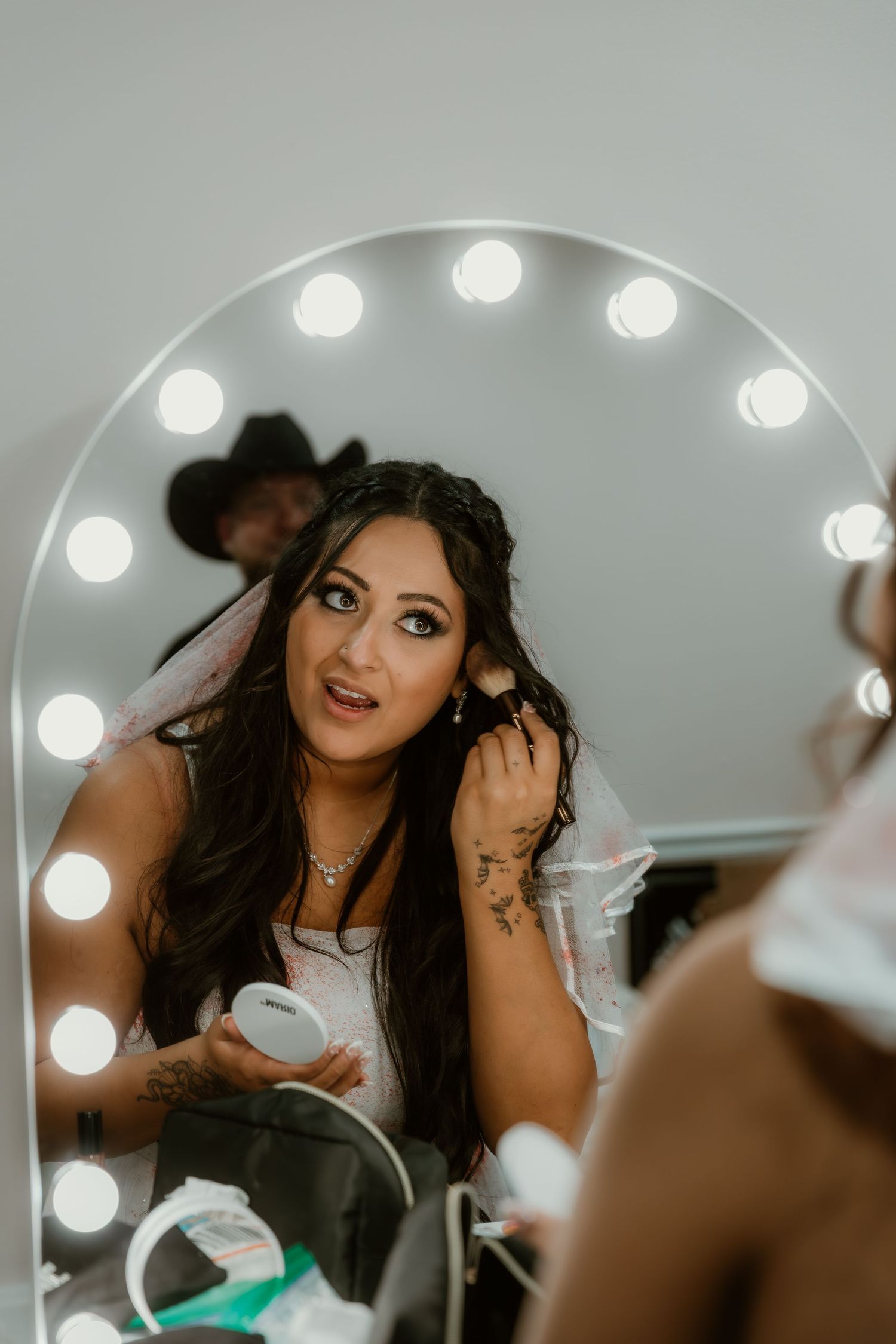 Bride refreshing her face for her wedding reception captured by illinois elopement photographer
