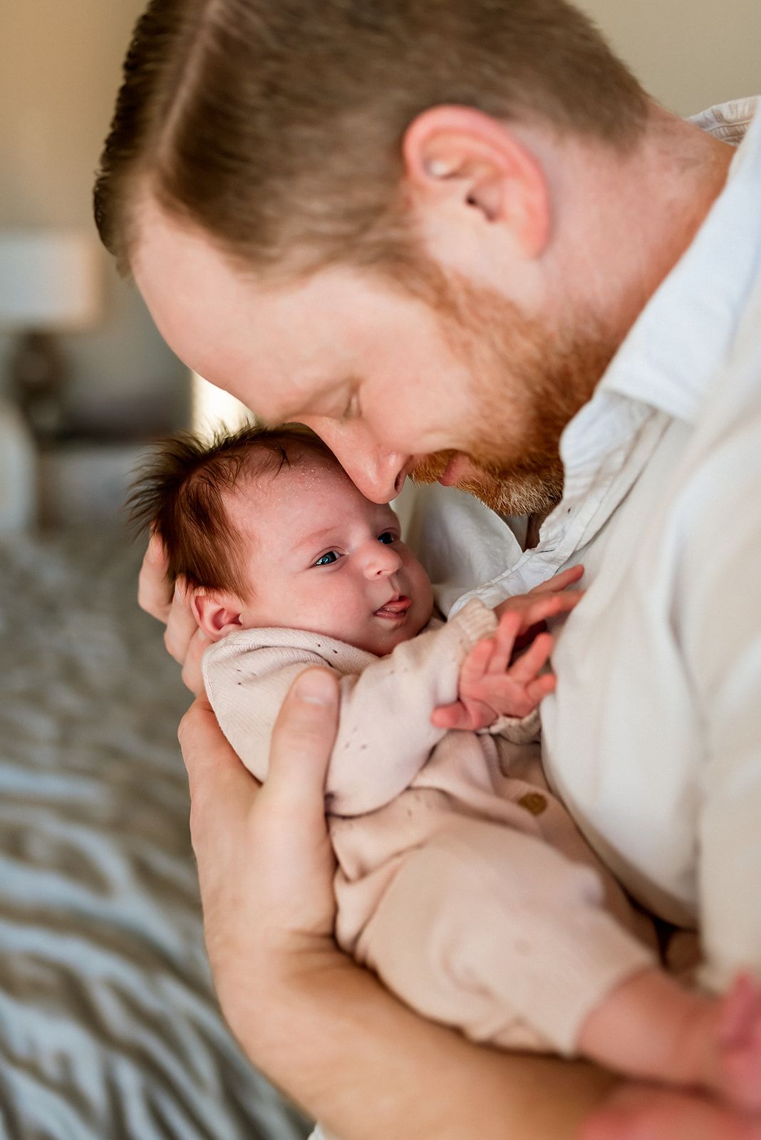 A tender moment between parent and newborn baby as they share an intimate close connection.