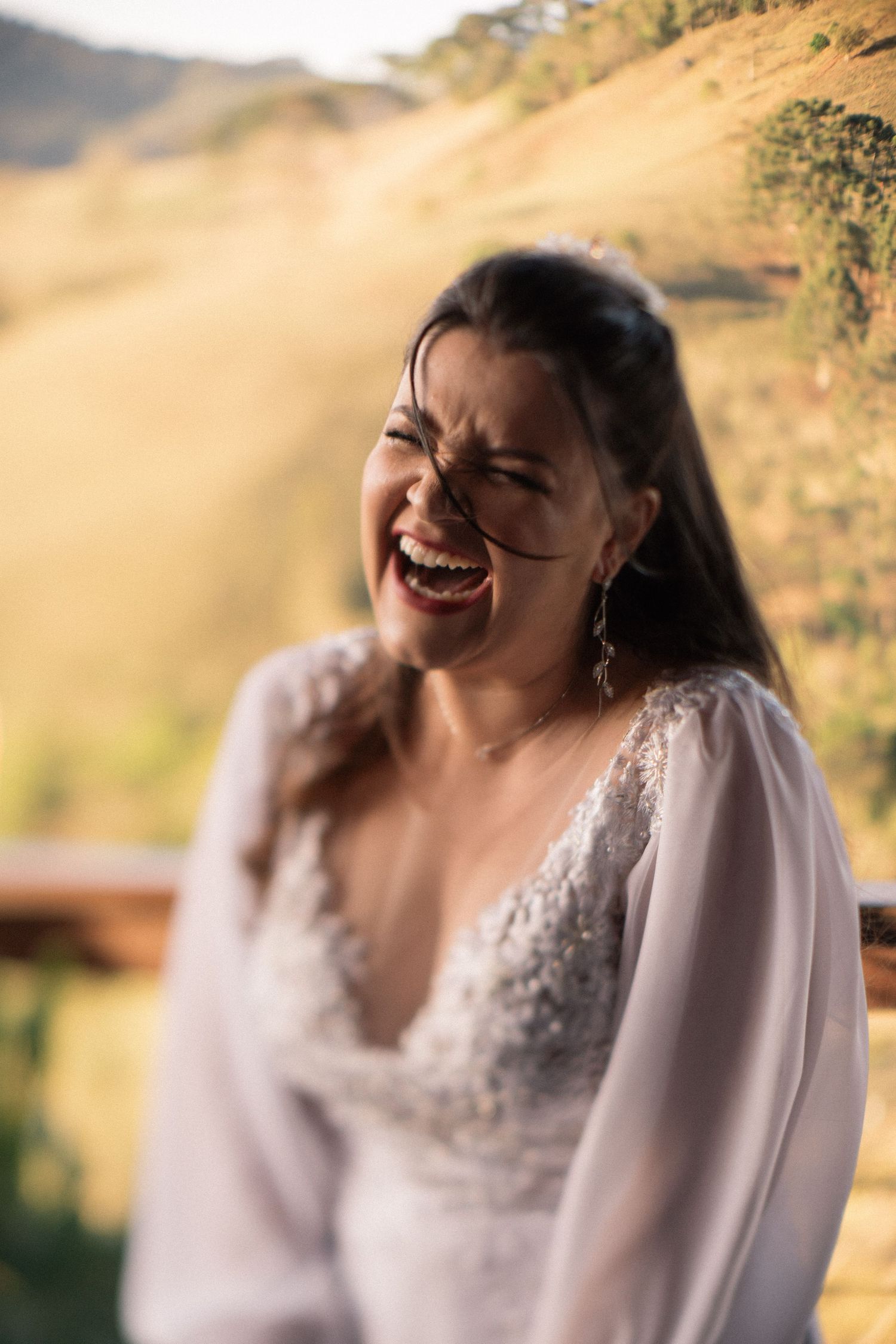 A joyful candid moment captured during an outdoor mountain wedding ceremony.