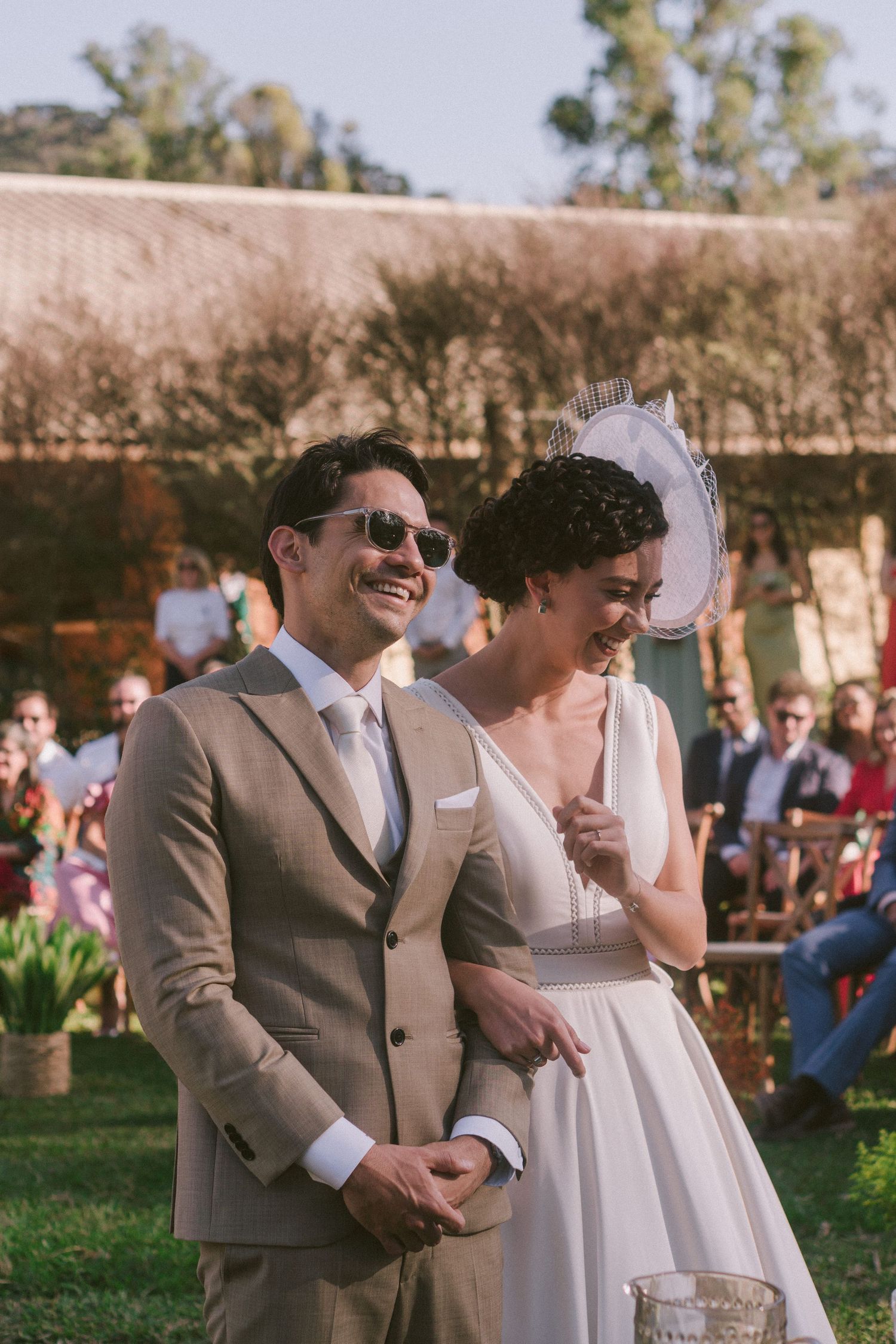 A joyous outdoor wedding ceremony with happy couple in formal attire.