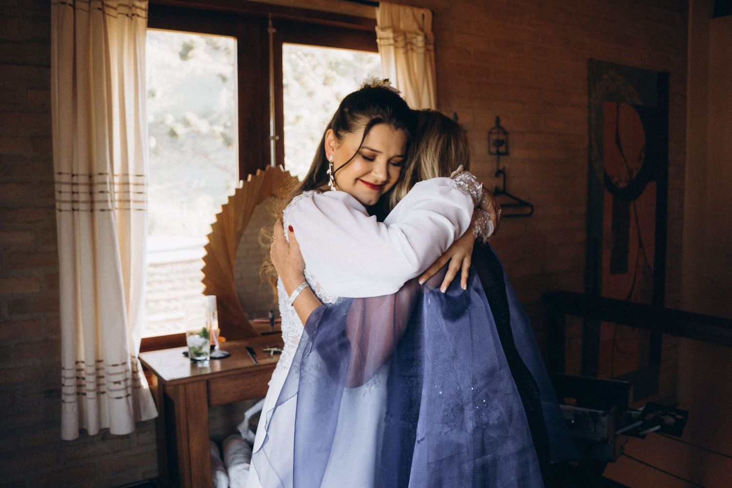 A tender embrace between two people in a rustic cabin interior.