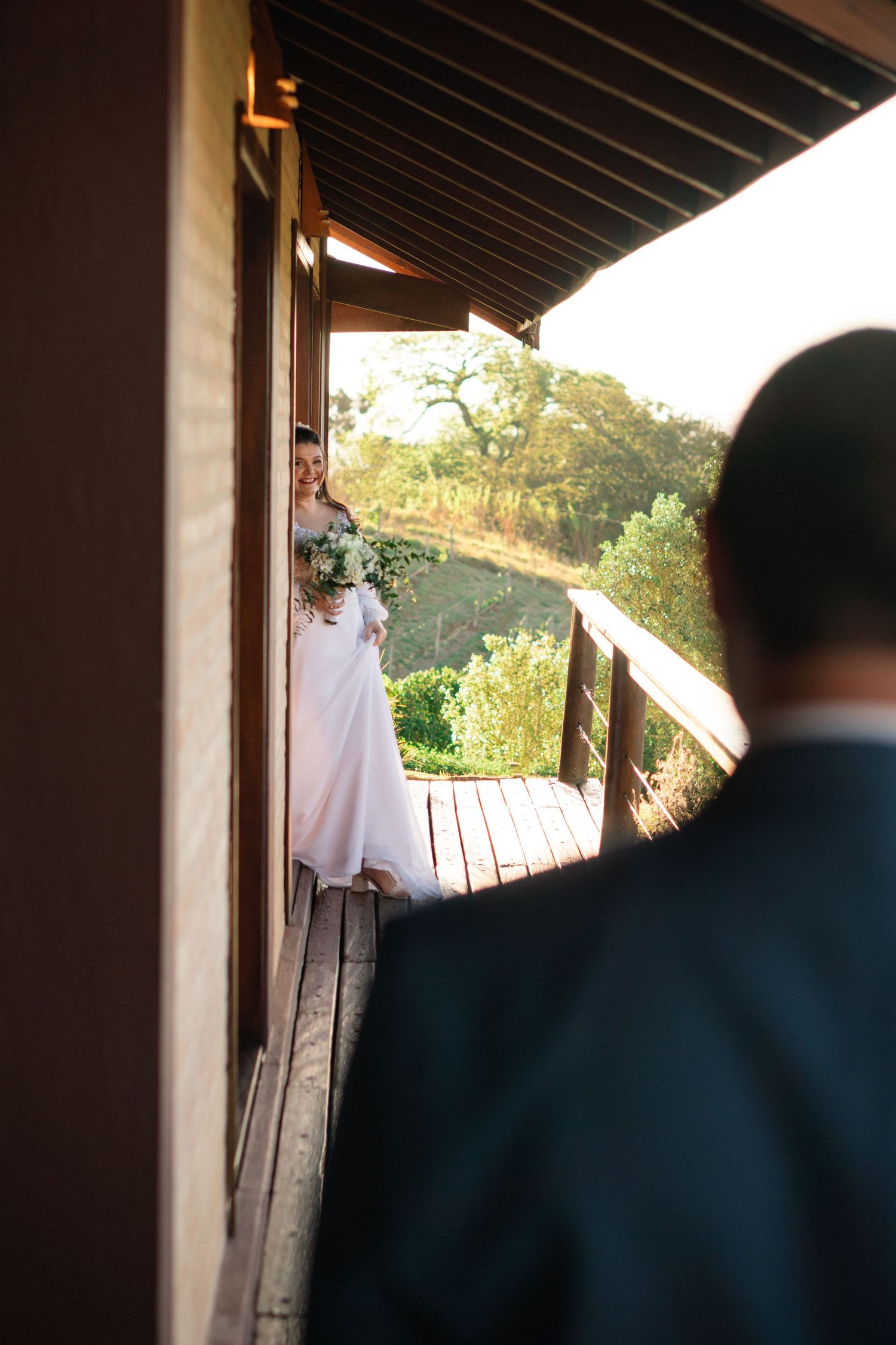 A wedding scene on a wooden porch with scenic mountain views in the background.