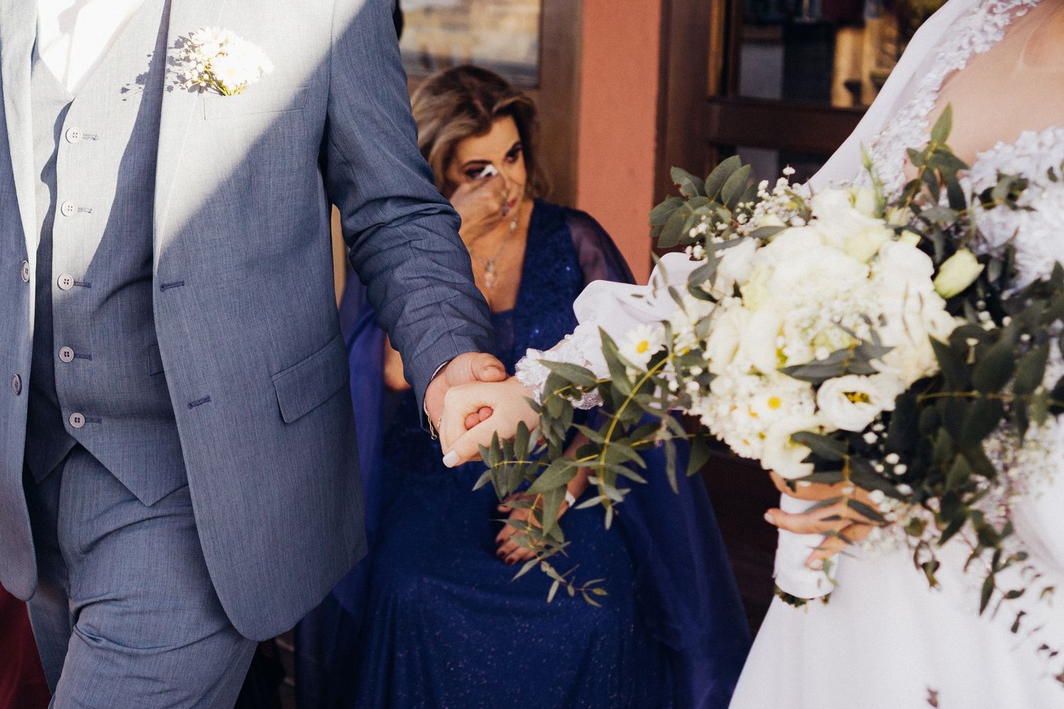 A wedding scene with elegant floral bouquets and formal attire.