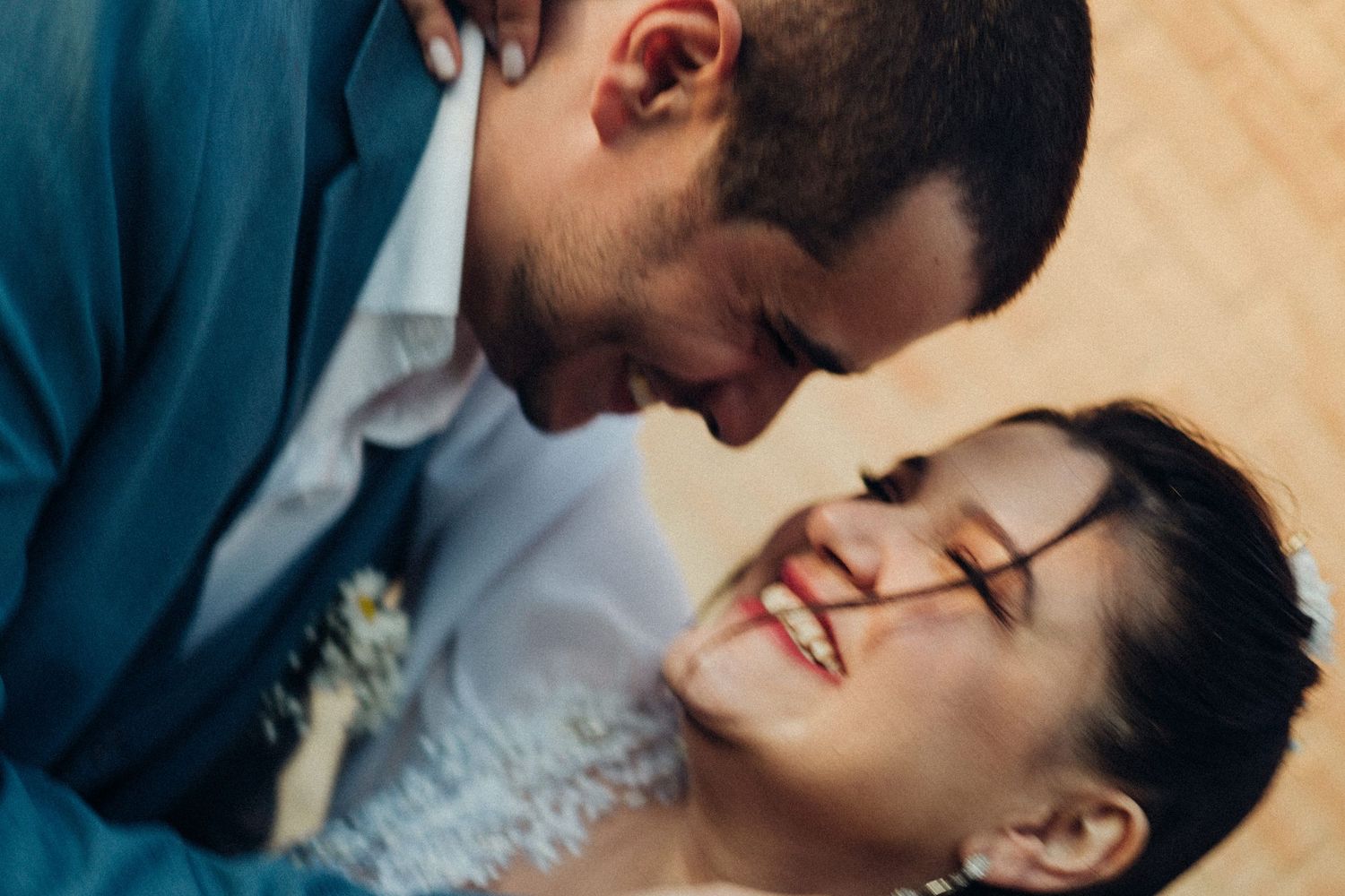 A tender intimate moment between newlyweds sharing laughter together.