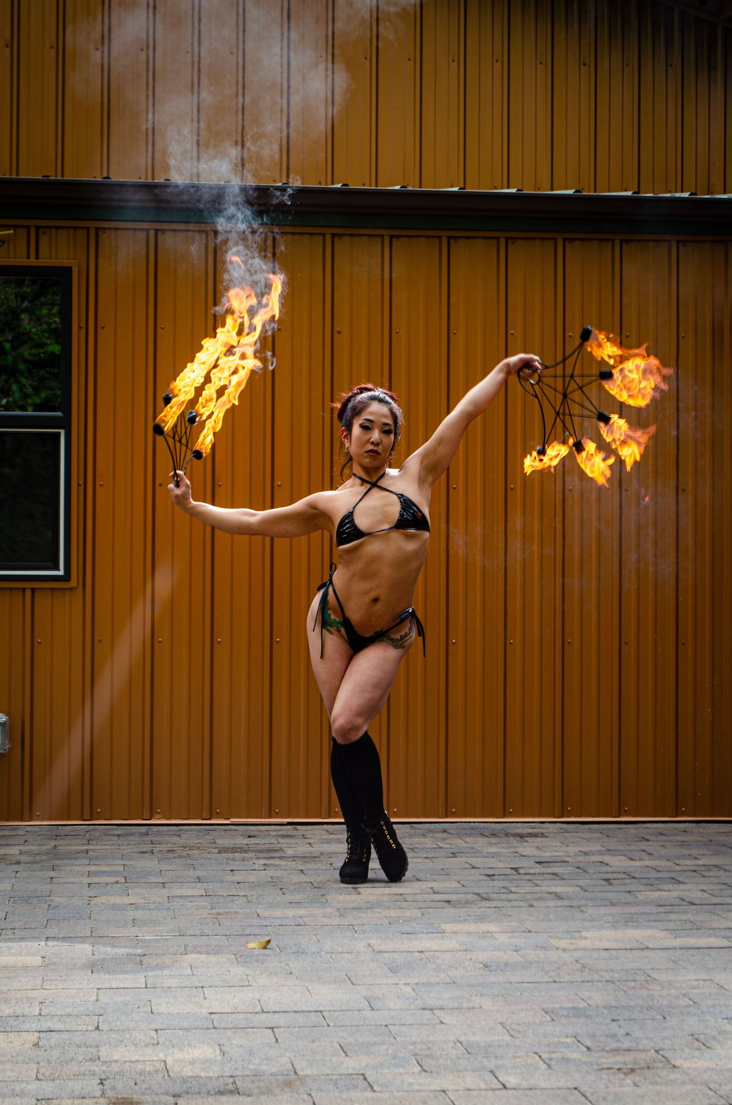 Photo of performance with fire fans handled with such grace and control.