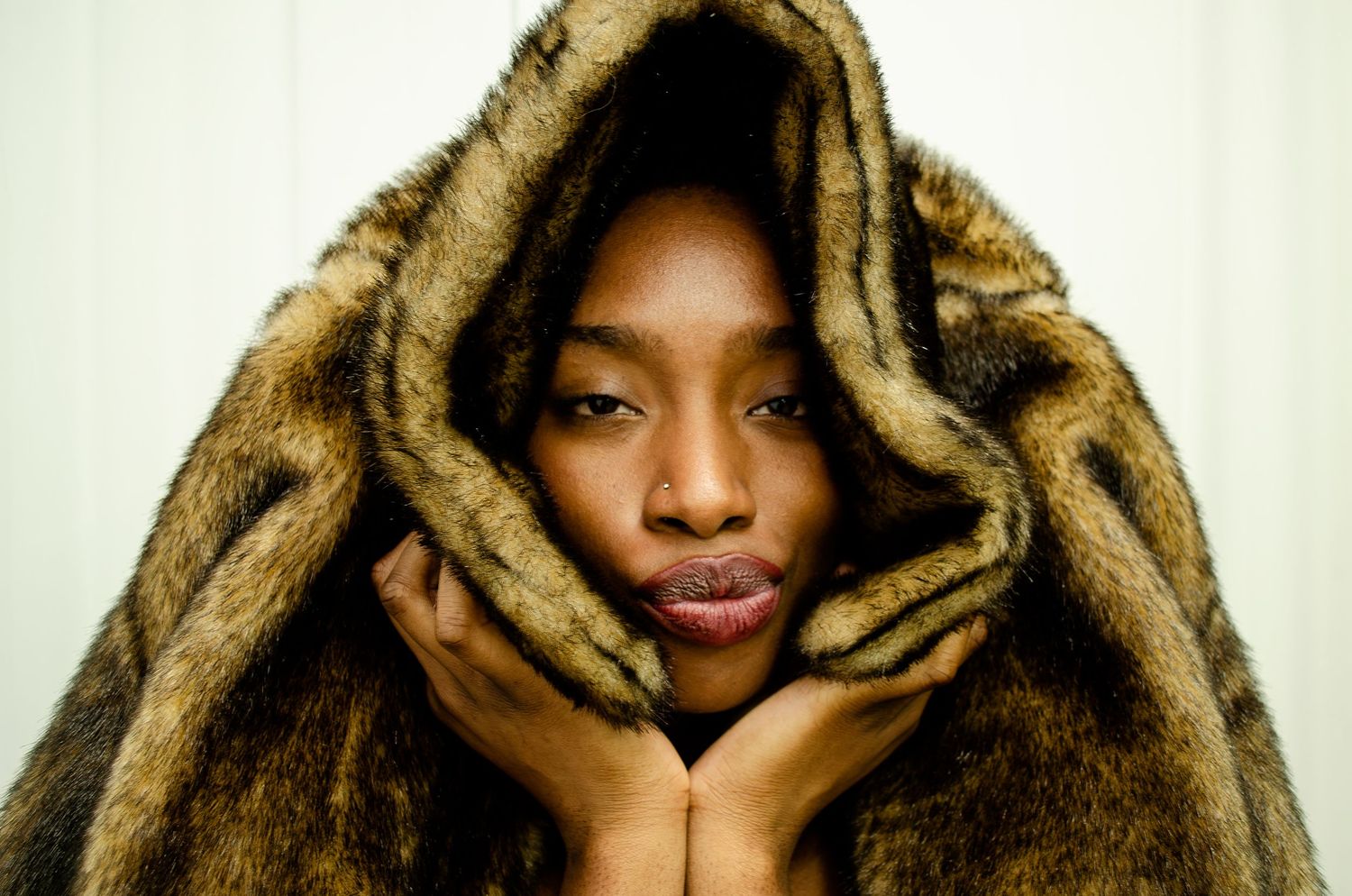 Studio shoot close up fashion editorial in a fur coat.