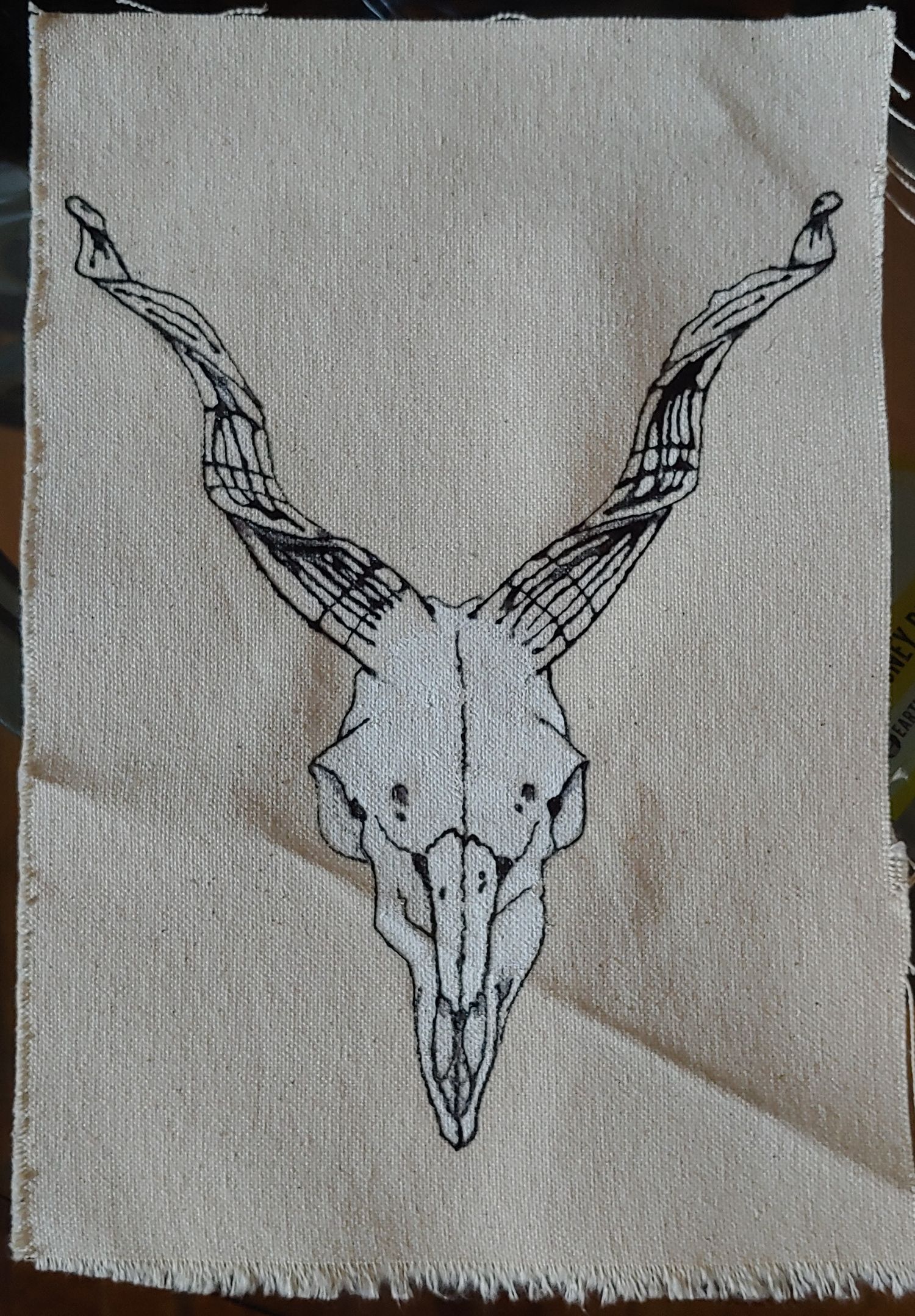 Capricorn skull tattoo design on canvas with gesso and temporary tattoo ink.
