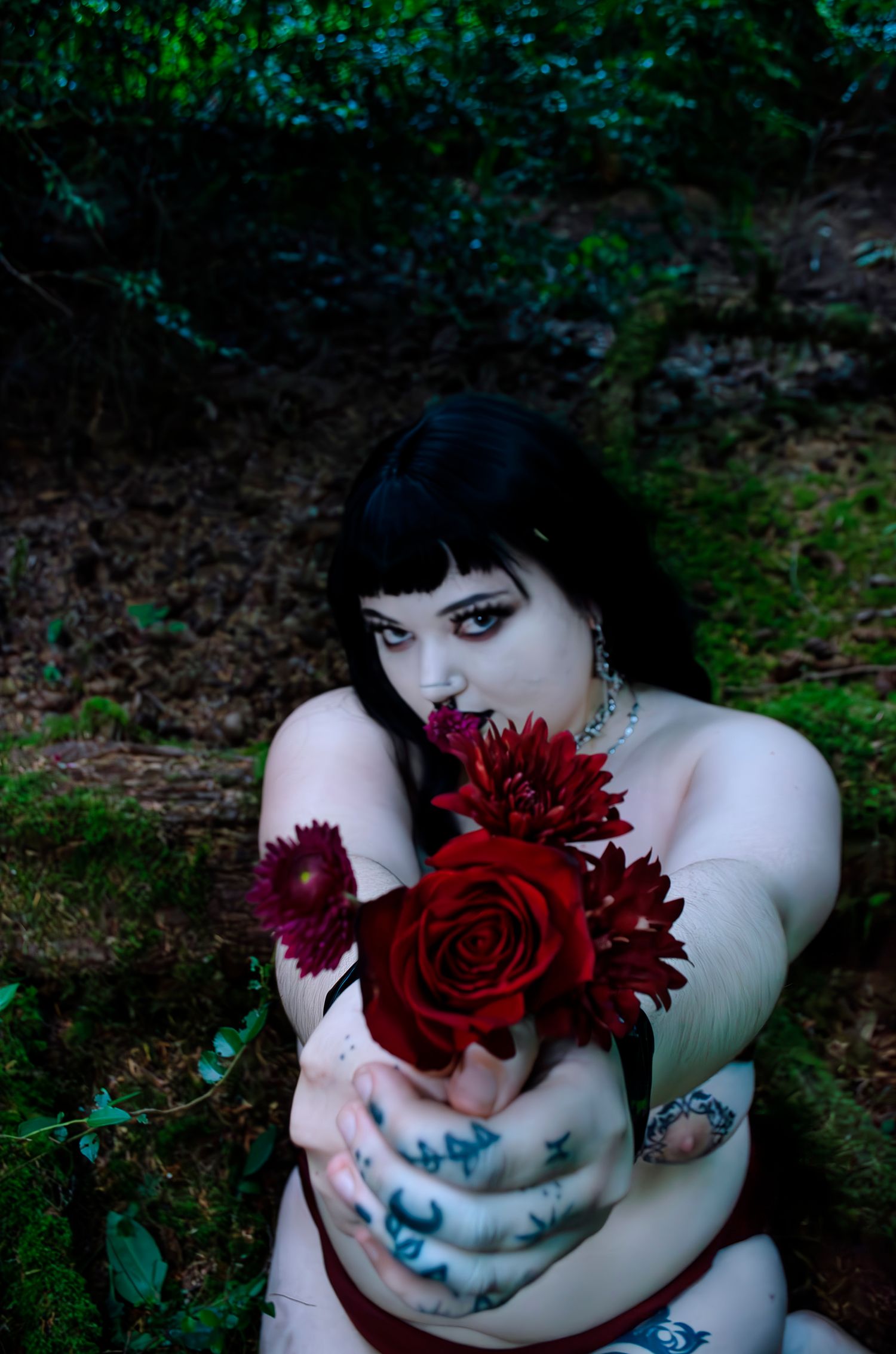 Nude, bondage, floral, dark and alternative photoshoot in the forest presenting flowers.