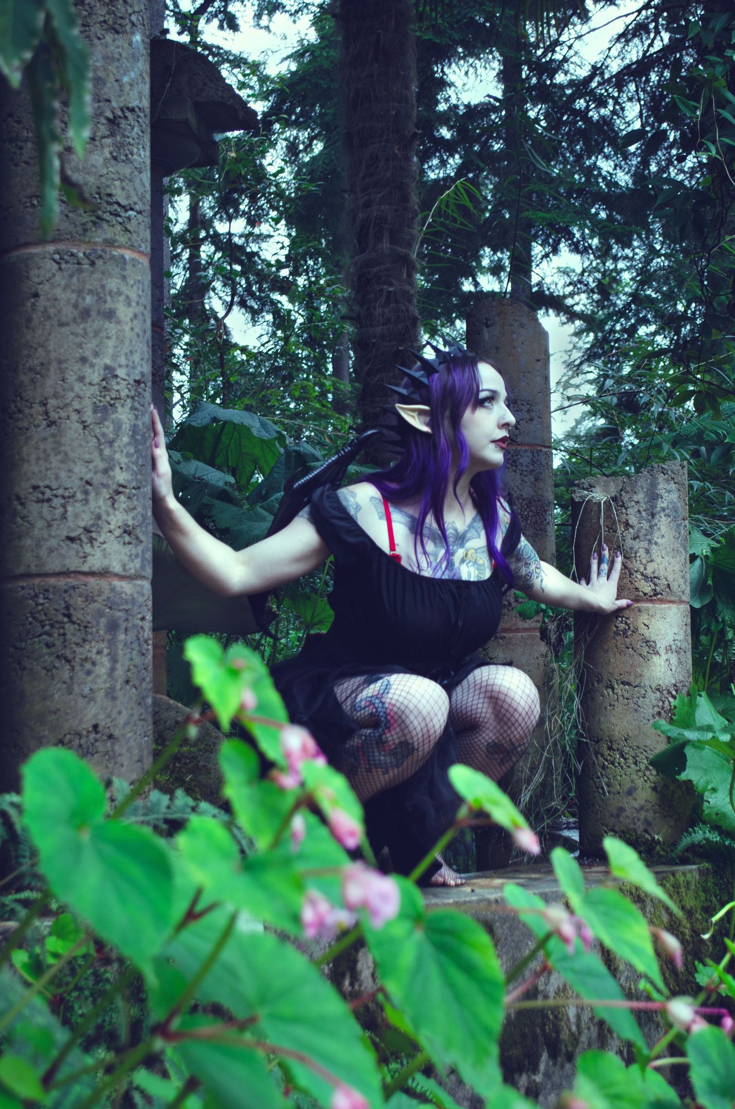 Photo of a dark fairy in her home of a abandoned garden.