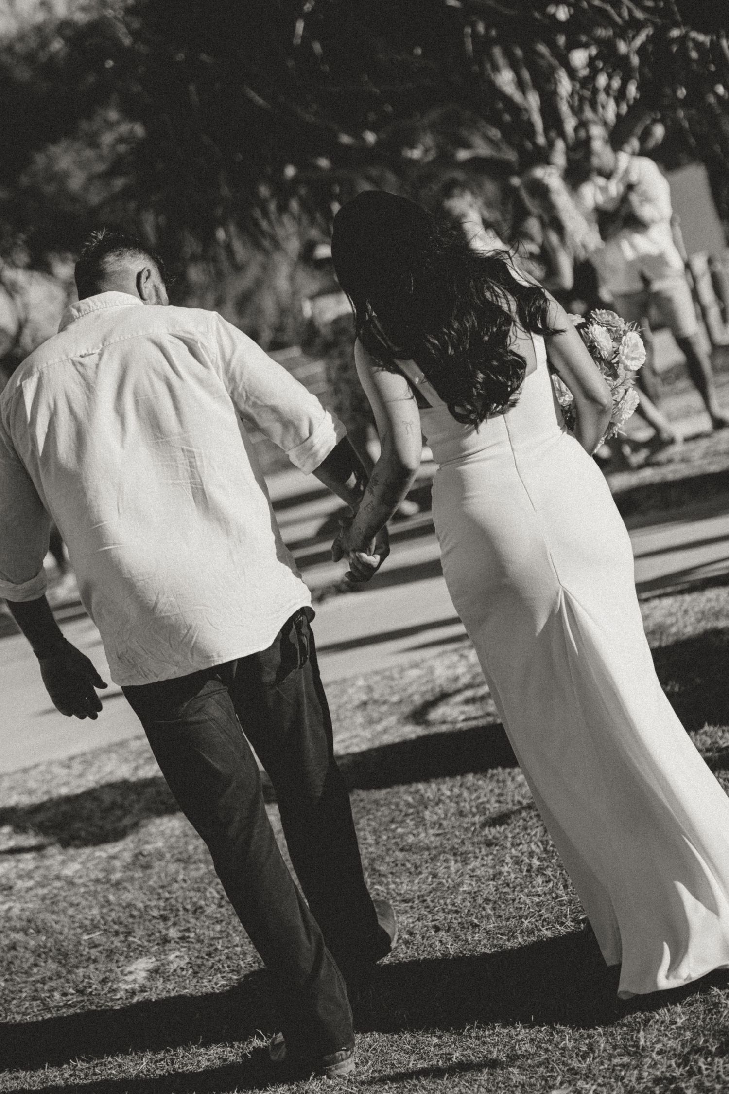 Black and white photo of couple walking together outdoors.