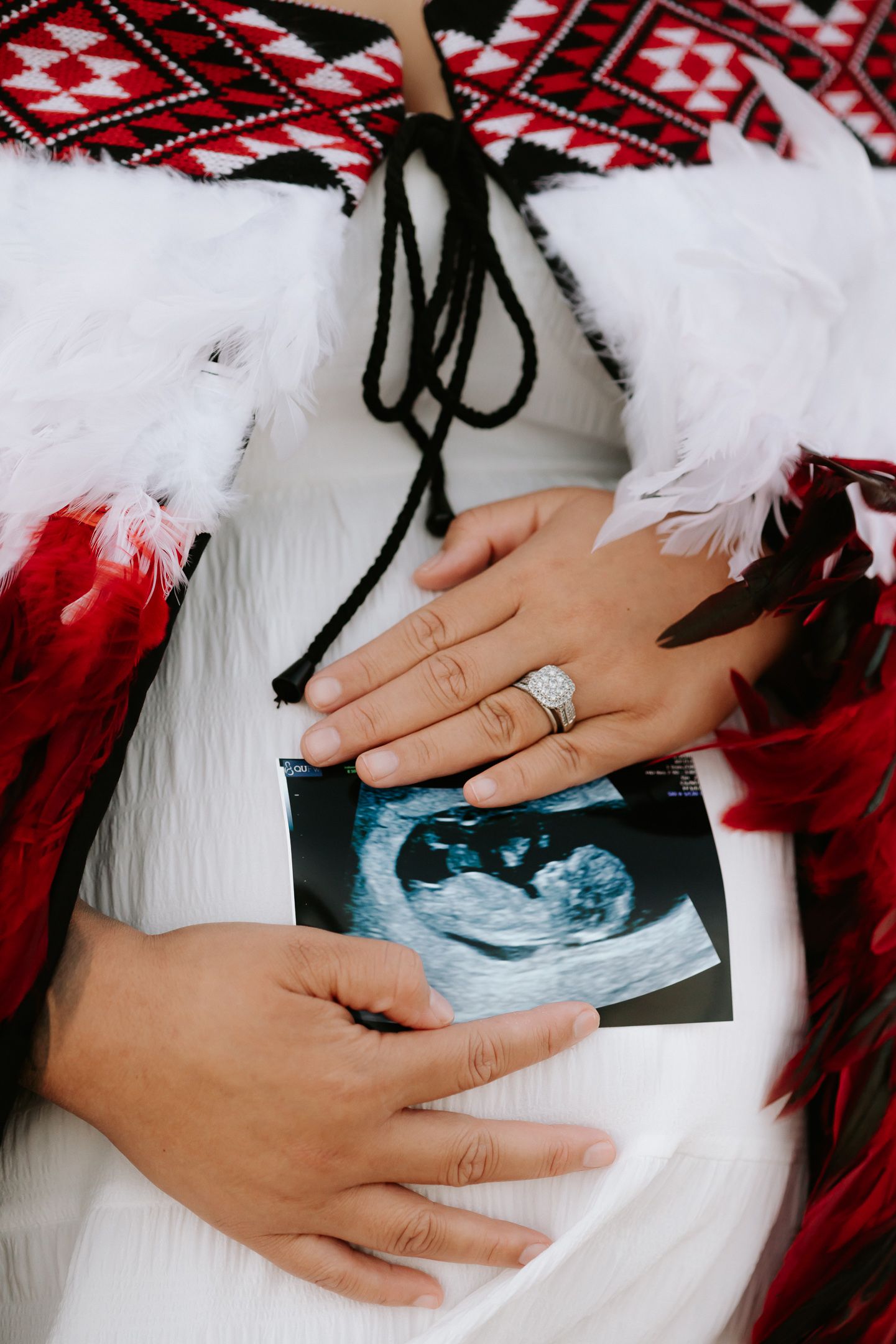 Hand with engagement ring shown in a series of photos with red and white holiday decor elements.