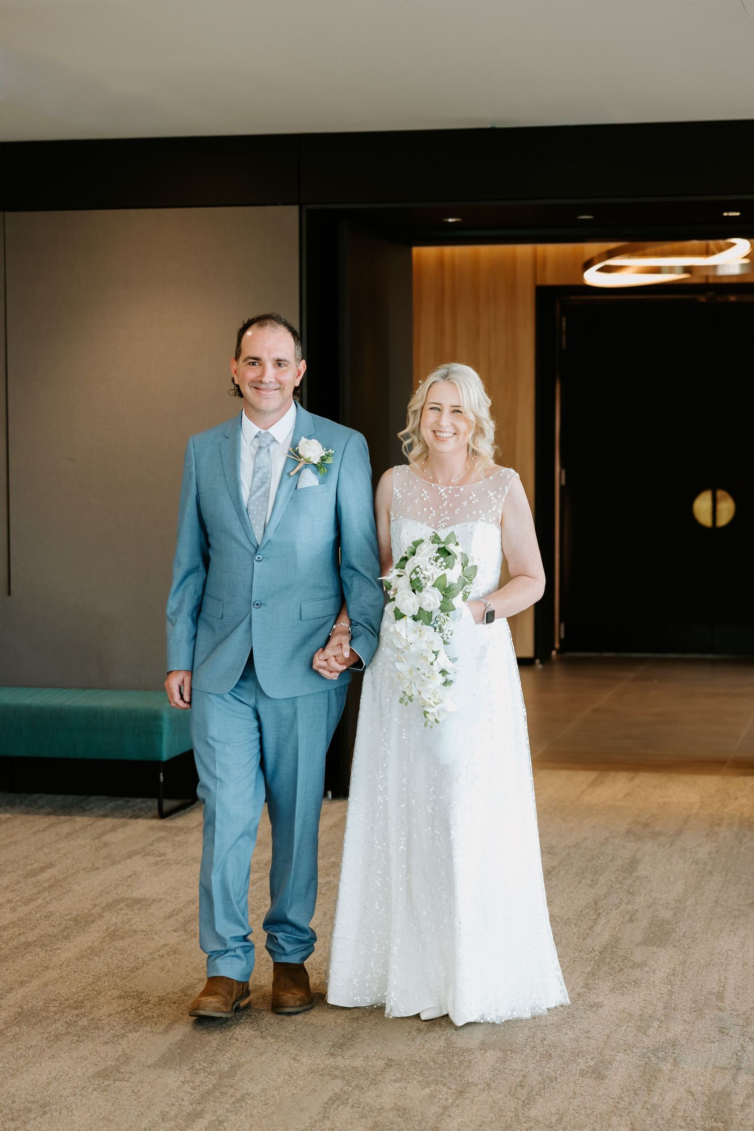 A couple in a light blue suit and white lace wedding dress pose together in a series of progressive wedding photos.