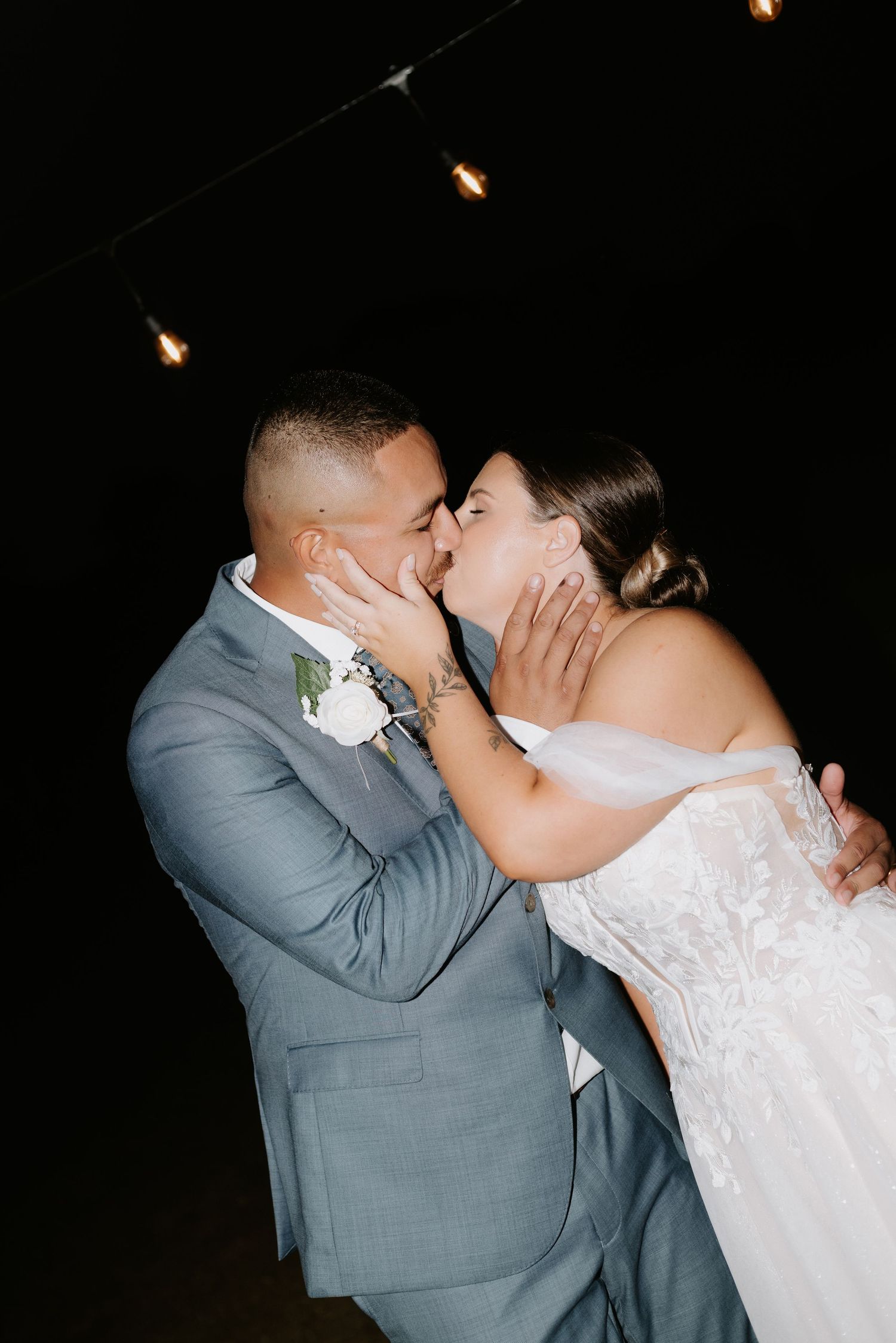 Romantic nighttime portrait of newlyweds sharing an intimate moment.