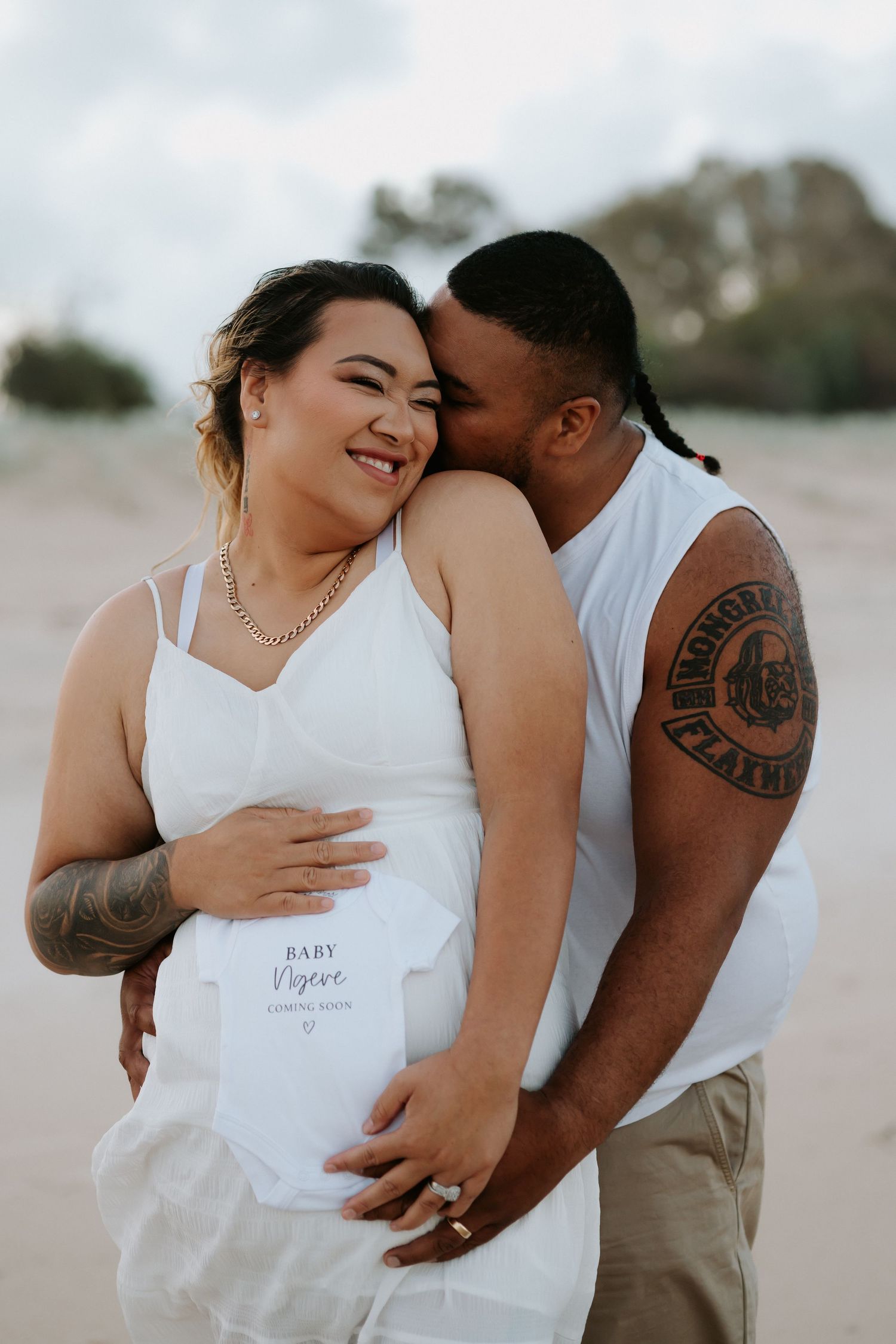 A romantic couple shares intimate moments on a beach in a series of five tender engagement photos.