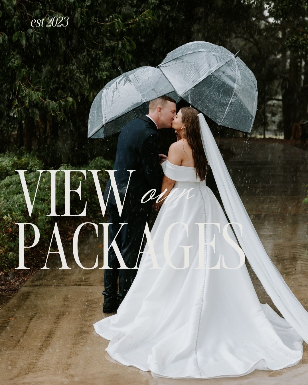 A bride and groom kiss under a clear umbrella in the rain, with text reading View Our Packages, est 2023.