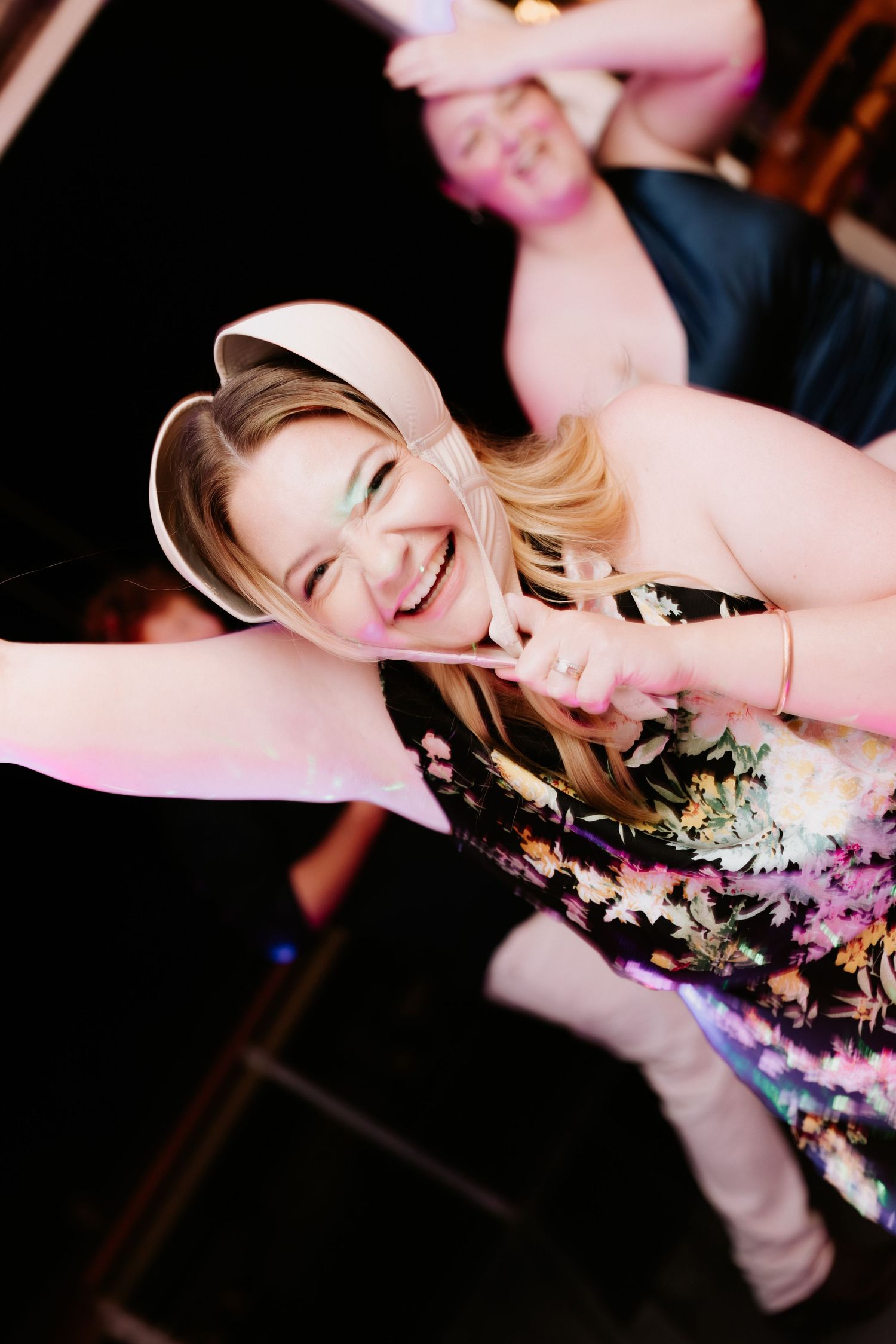 A sequence of photos showing a person dancing and spinning with confetti and sparkles in a dark party setting.