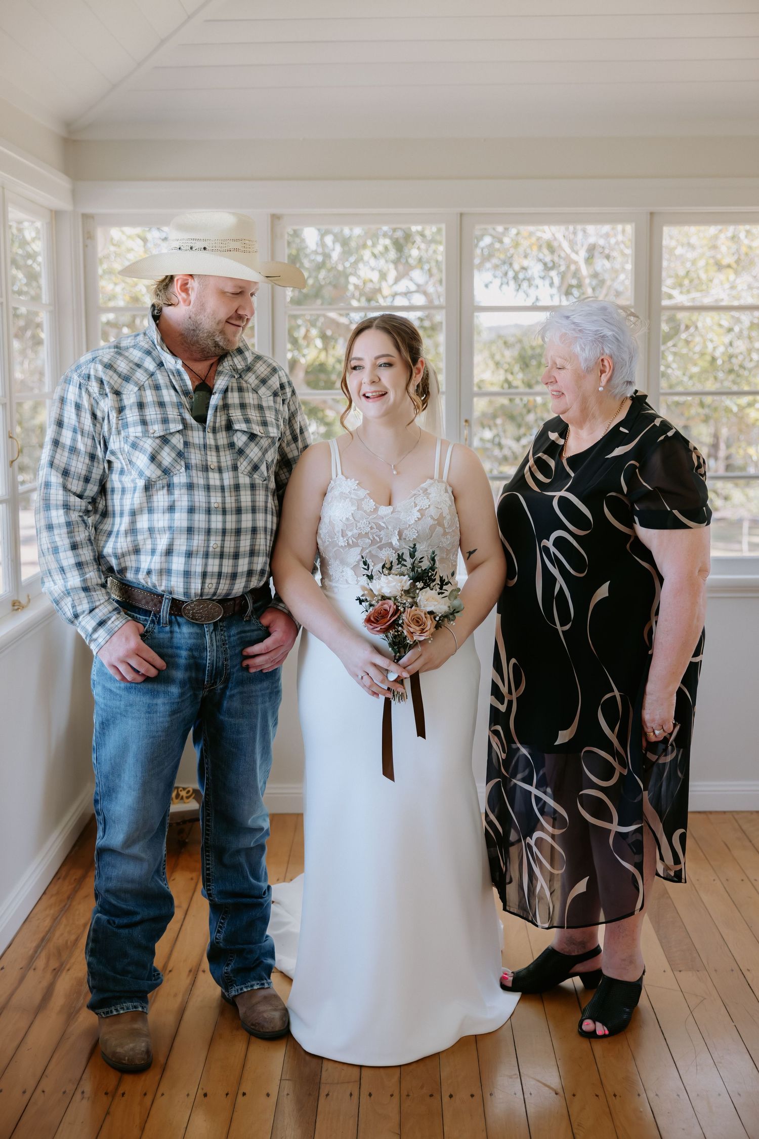 Sweet candid moment captured in a bright indoor setting with white walls and hardwood flooring.