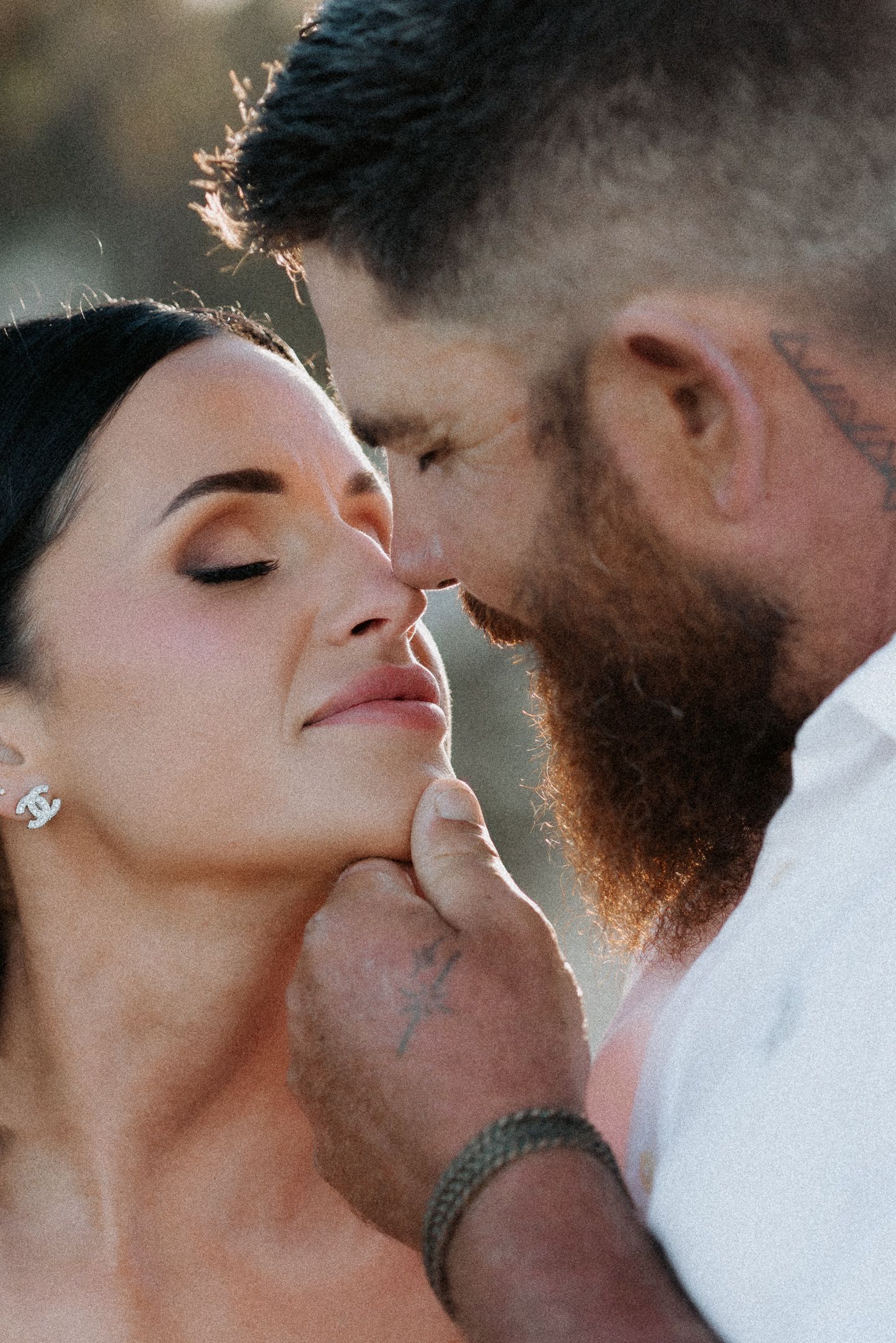 A romantic couple sharing intimate close-up moments with soft lighting and gentle expressions.