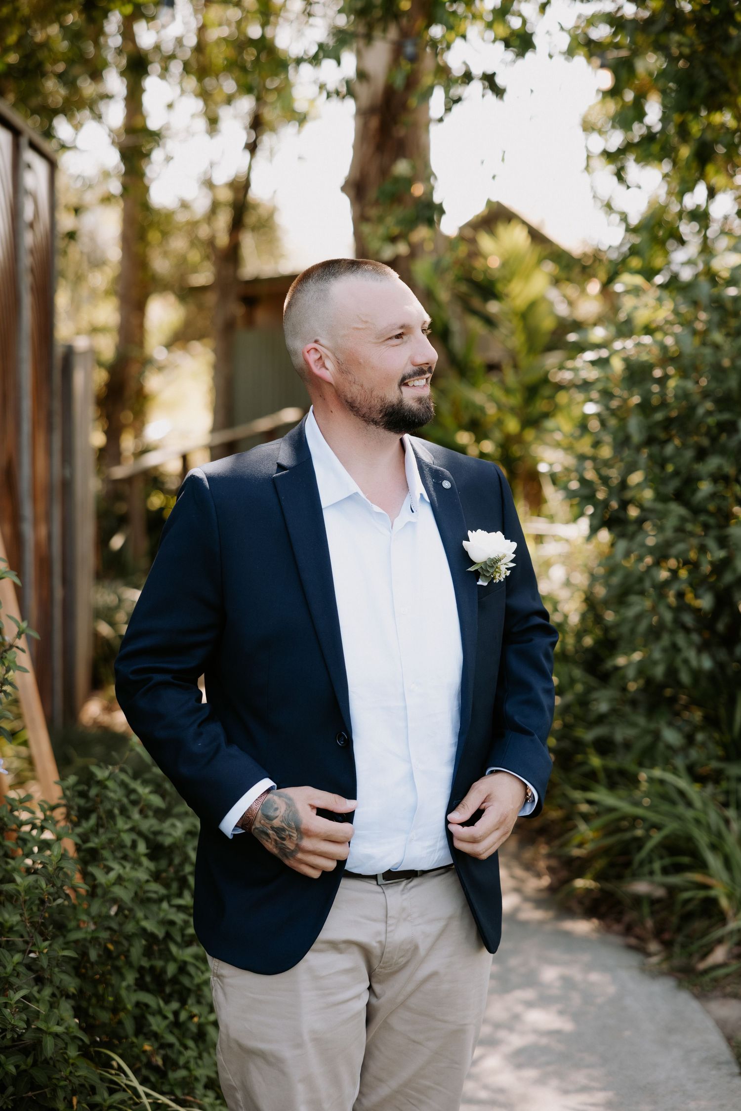 Casual outdoor wedding portraits in a garden path with natural lighting.