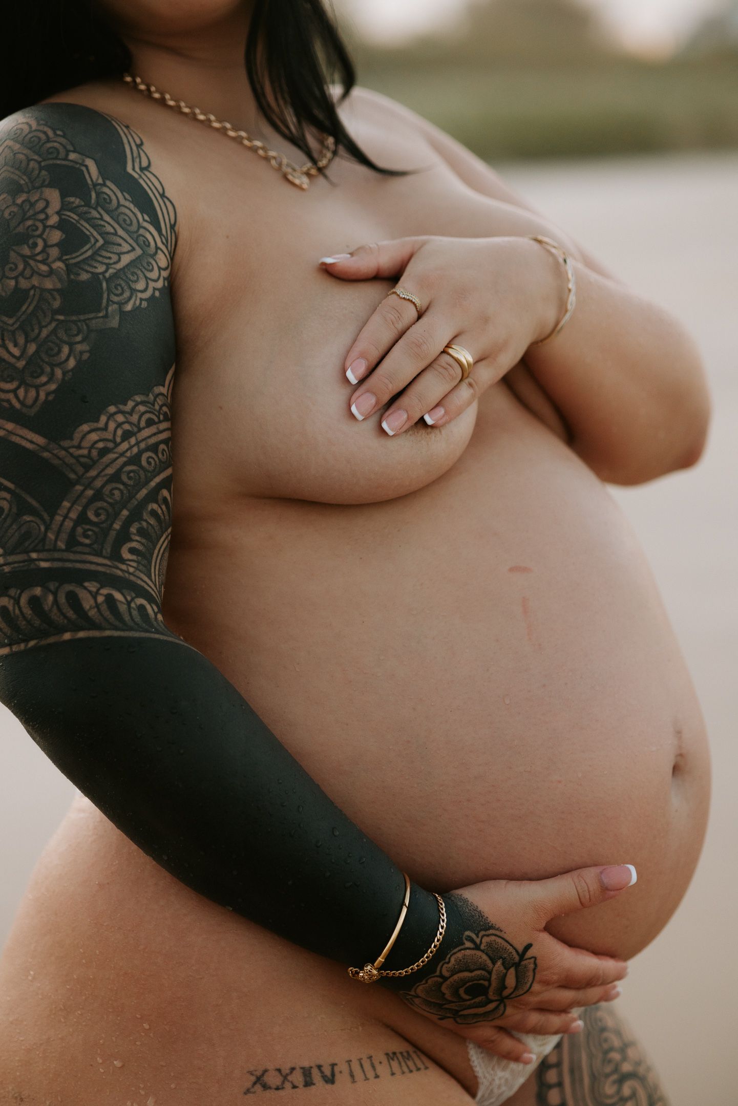Close-up photos showing a pregnant belly with visible tattoos and jewelry in various intimate angles.