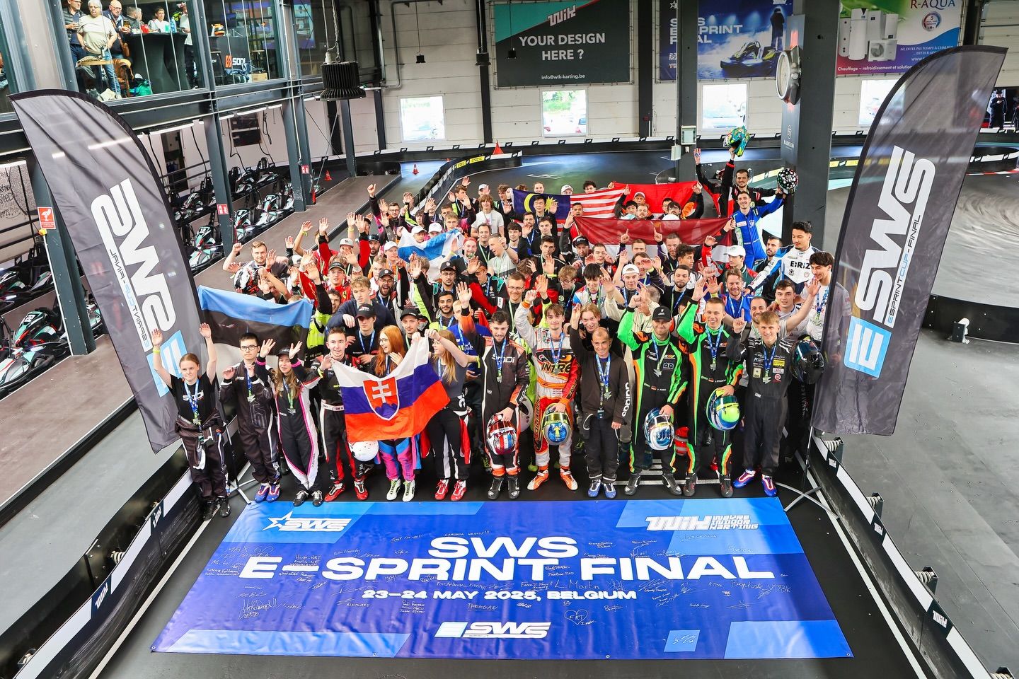 Large group of esports competitors gathered for a championship final event.