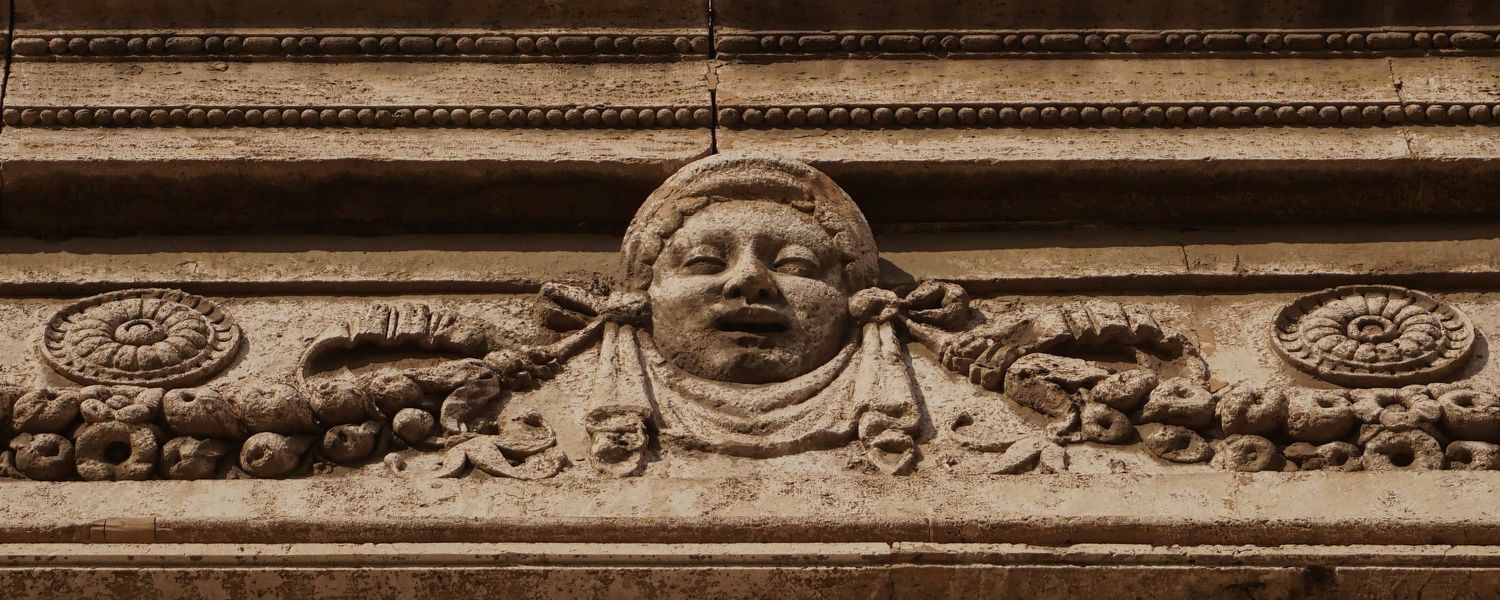 Italy – bas relief in Trastevere - Rome – carved stone relief on a historic building façade, photo by Eduardo Bartoli
