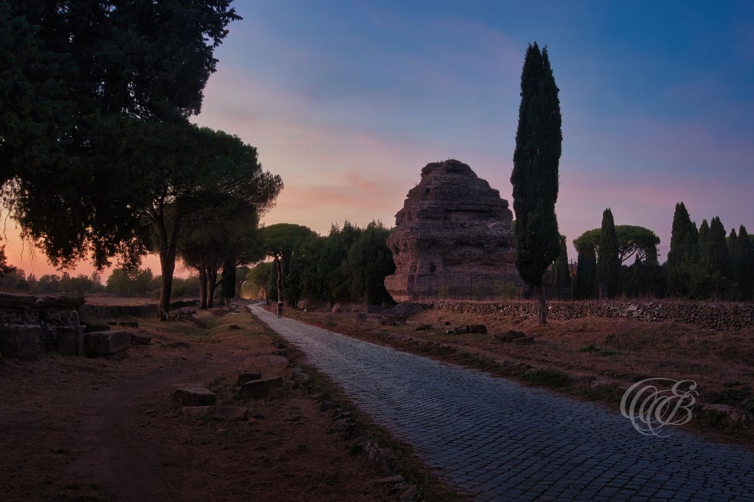 Italy – Appian Way at dusk - Rome – ancient Roman road with stone paving at evening light, photo by Eduardo Bartoli
