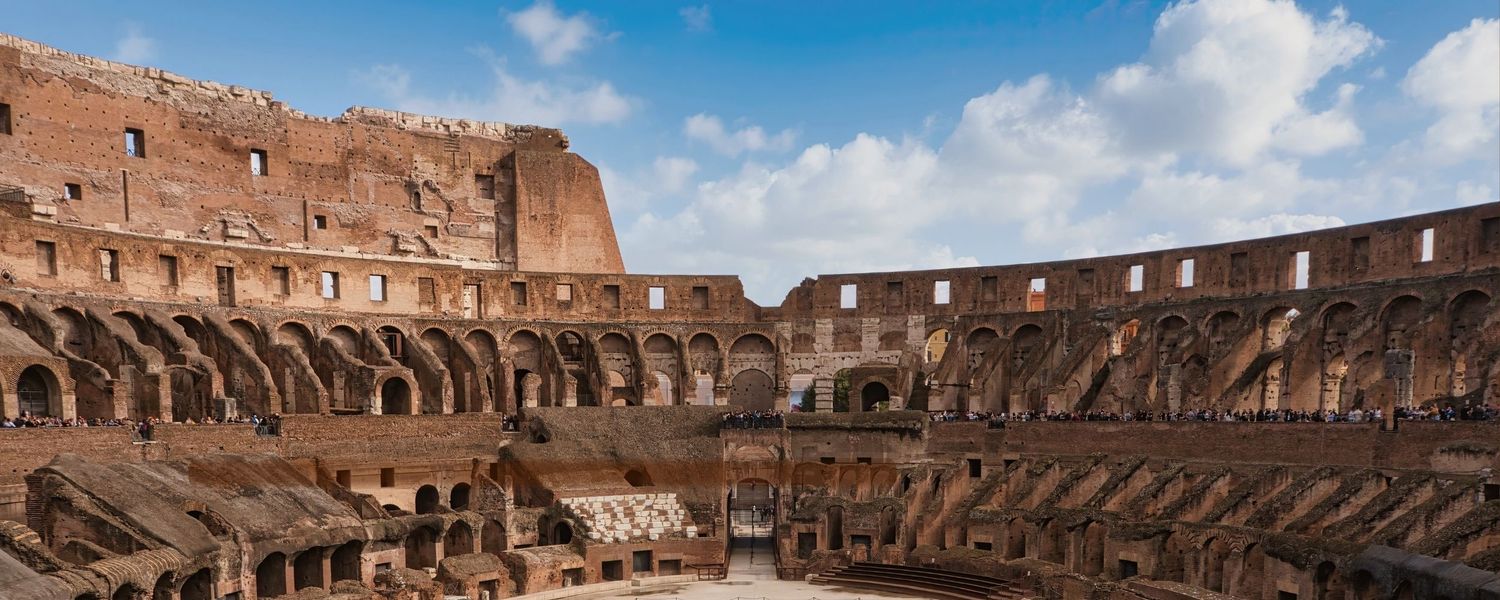 Italy – Colosseum interior at sunset - Rome – view of the ancient amphitheater arches in evening light, photo by Eduardo Bartoli