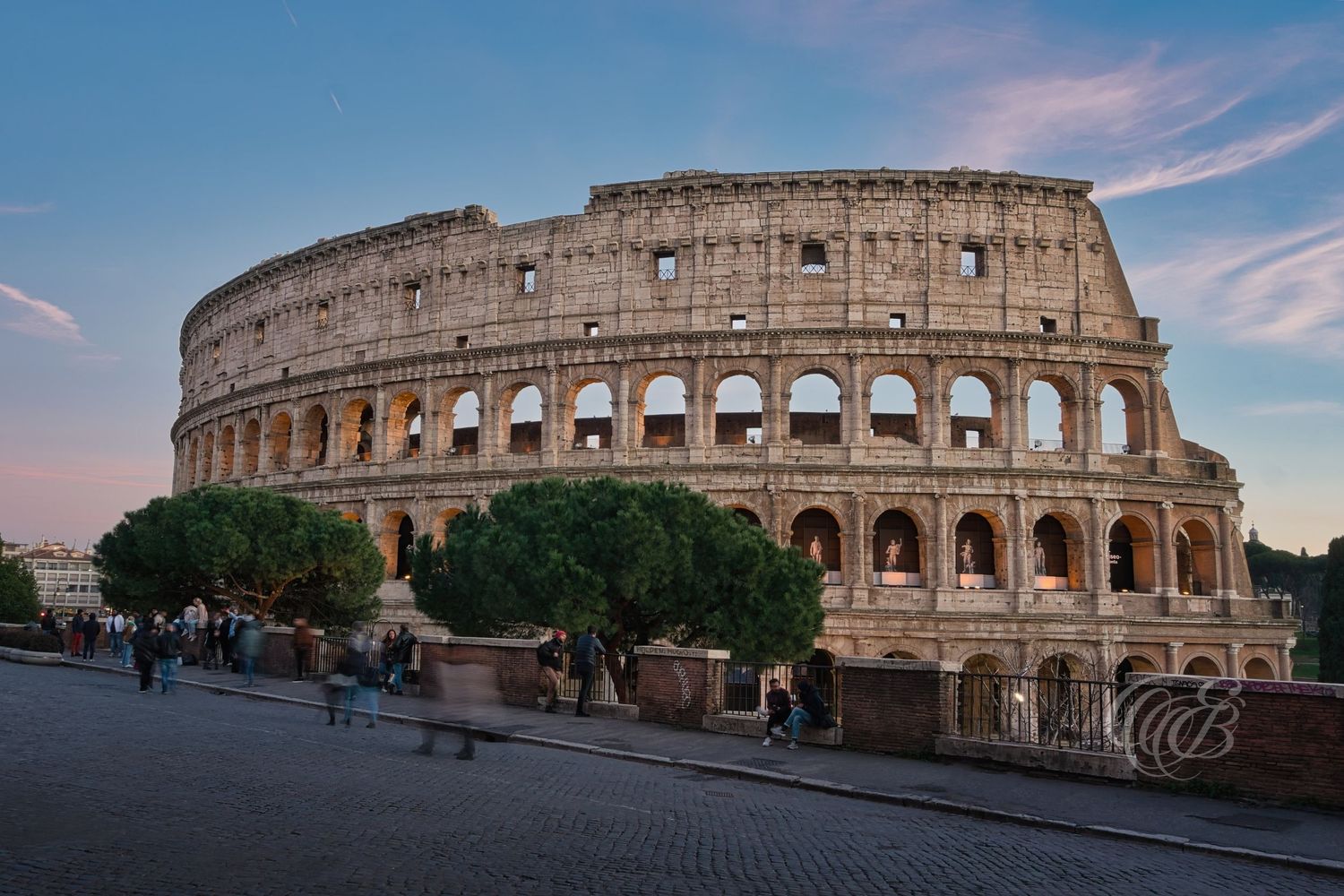 Italy – Colosseum at sunset - Rome – ancient Roman amphitheater illuminated in evening light, photo by Eduardo Bartoli